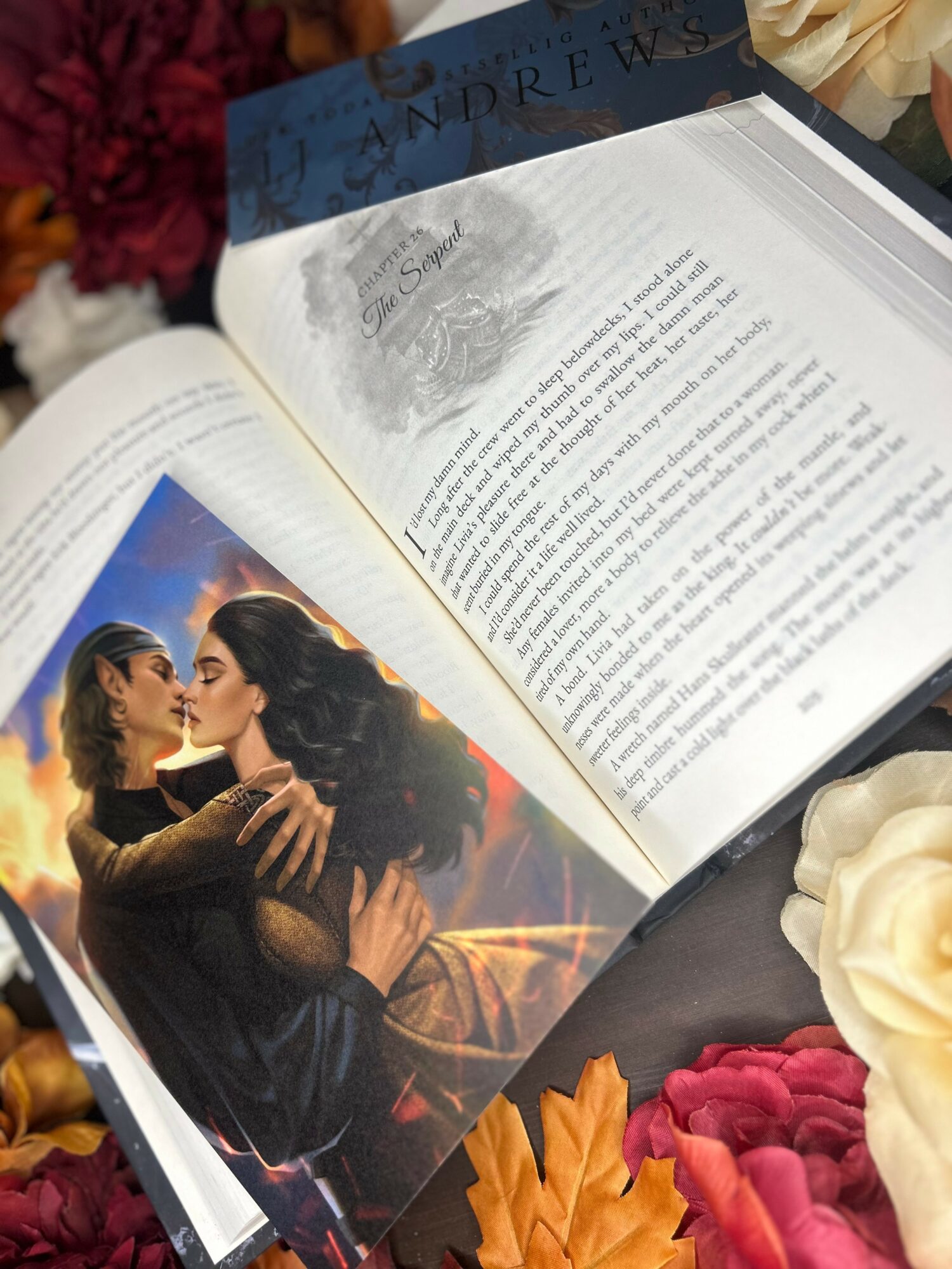 Open book with a movie poster of two women embracing, surrounded by flowers and autumn leaves.