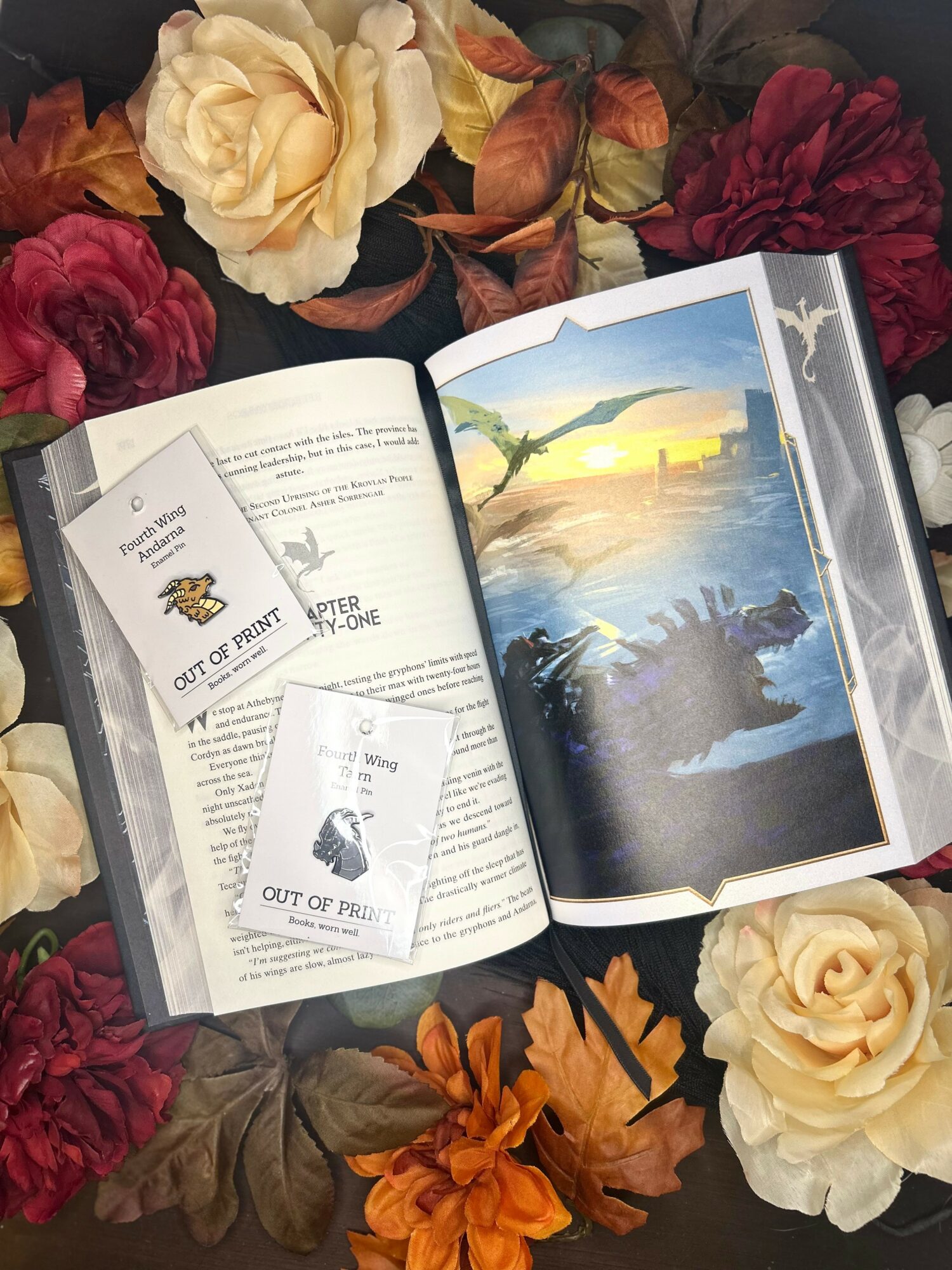 Open book with illustrations and tickets on a floral background with roses and leaves.