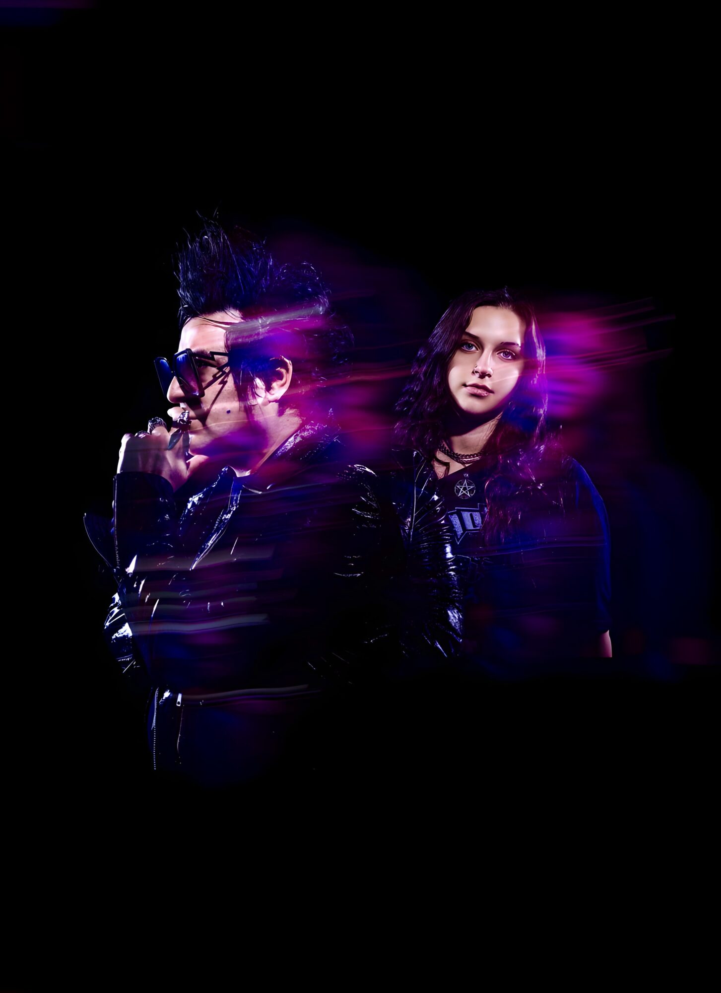 Two people with dark clothing and glasses, one with purple light effects, against a black background.