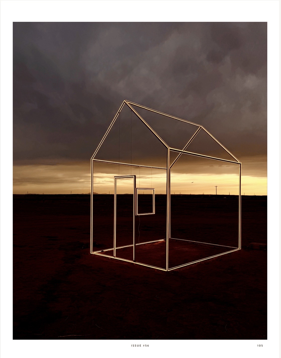 Outline of a house structure with a window, set against a dark, cloudy sky at sunset or dusk.