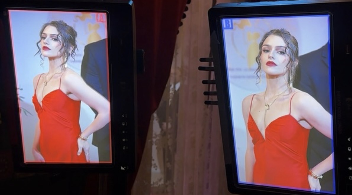 Two digital screens display a woman in a red dress with dark hair and makeup.