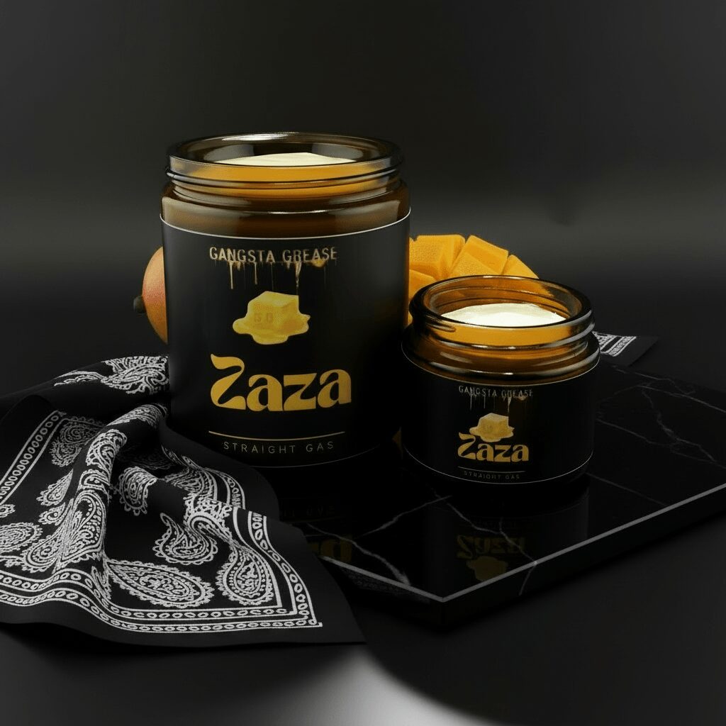 Two black jars of Zaza Gangsta Grease with gold labels, one open, on a black surface with a black and white cloth, dark background.