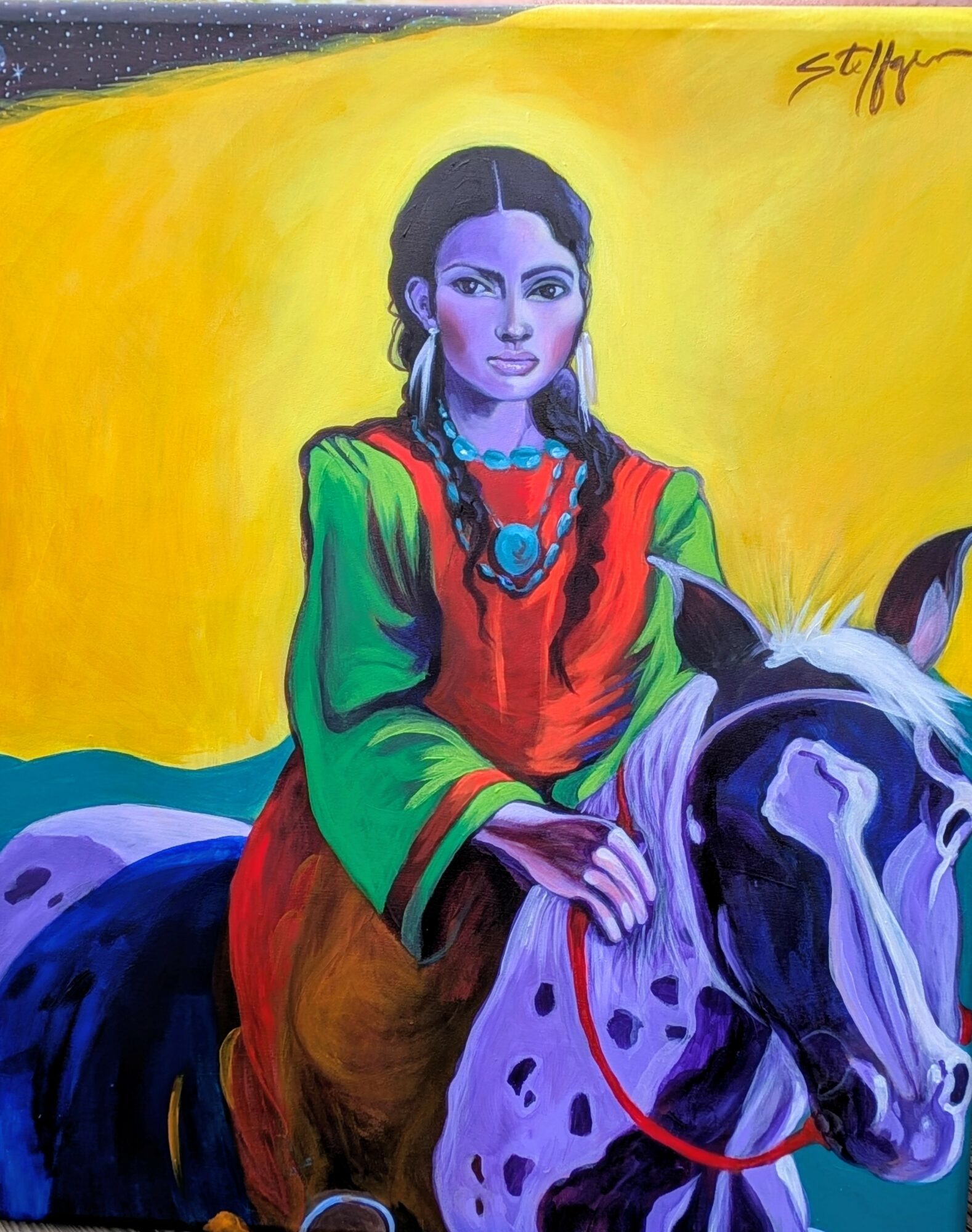 A woman with long dark hair, wearing a green and red dress with jewelry, rides a white horse with black spots against a yellow background.