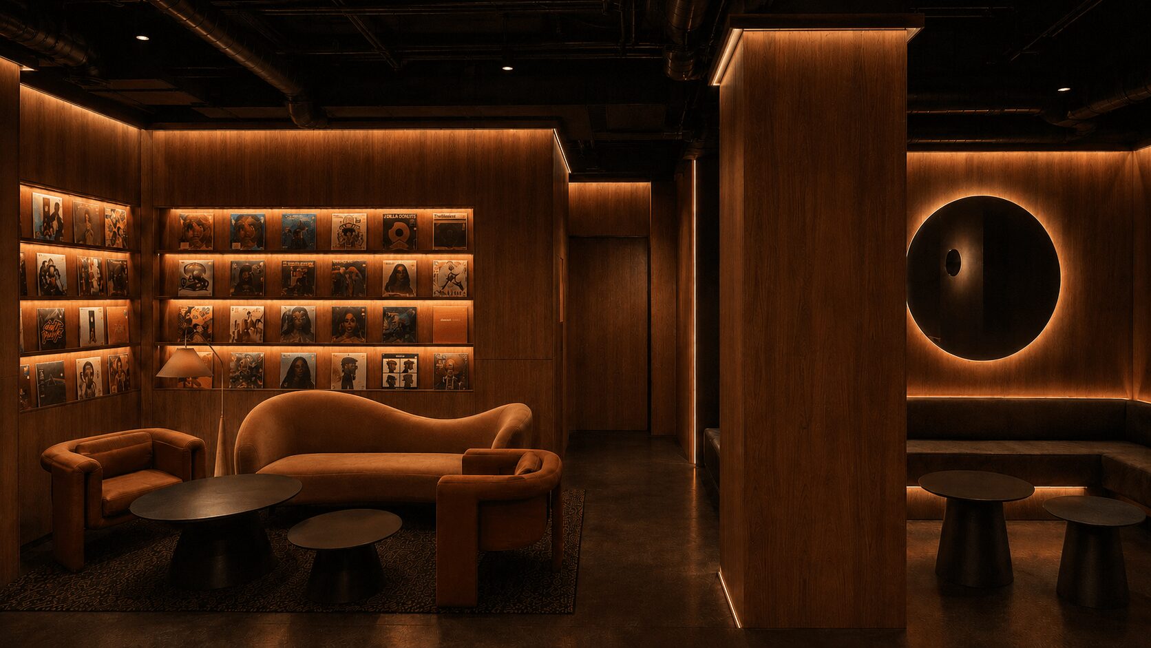 Interior of a dimly lit lounge with wooden walls, shelves, and seating areas, including a curved sofa and round tables.
