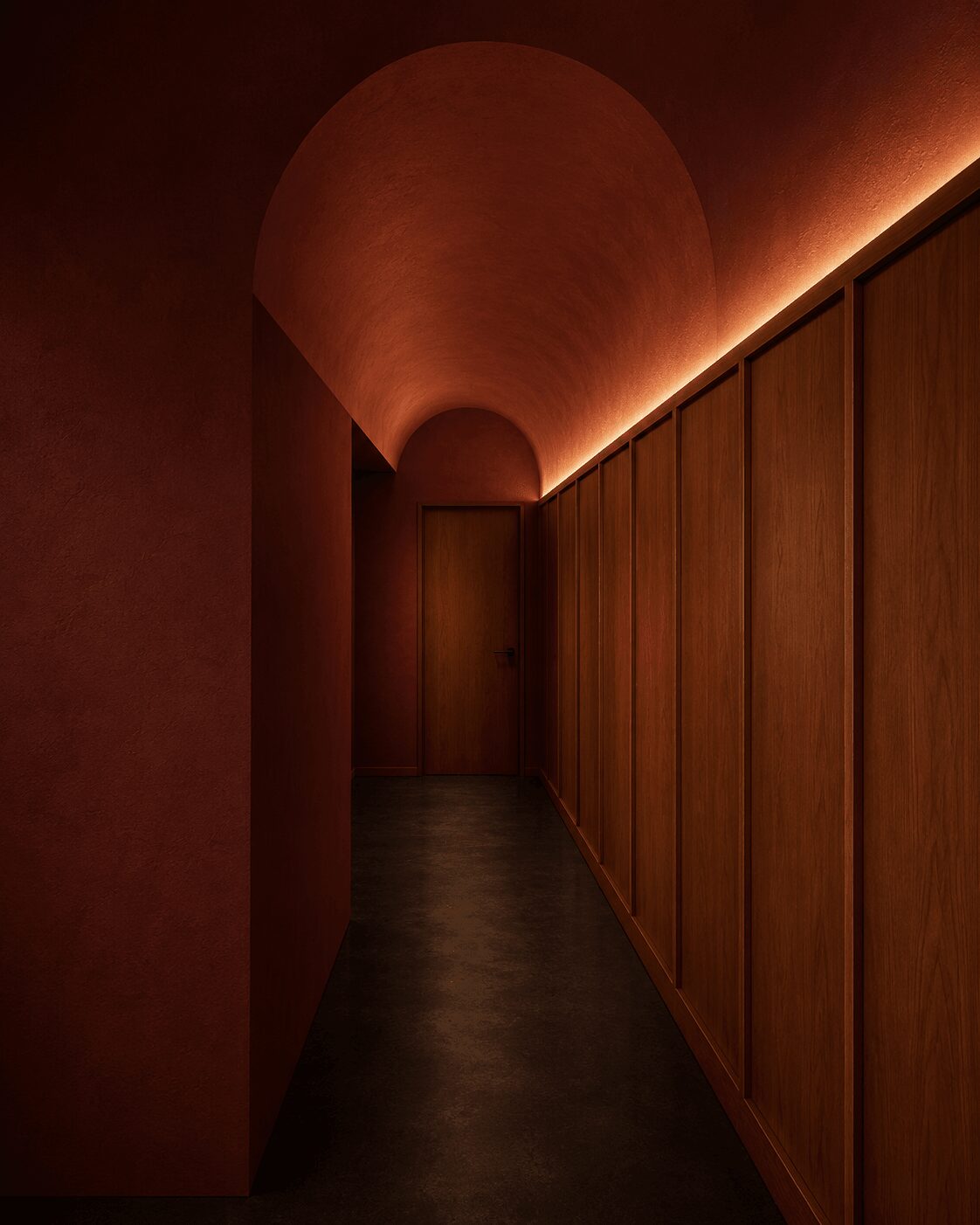 A dimly lit corridor with a curved ceiling, wooden panels on the right, and warm lighting along the ceiling edge.