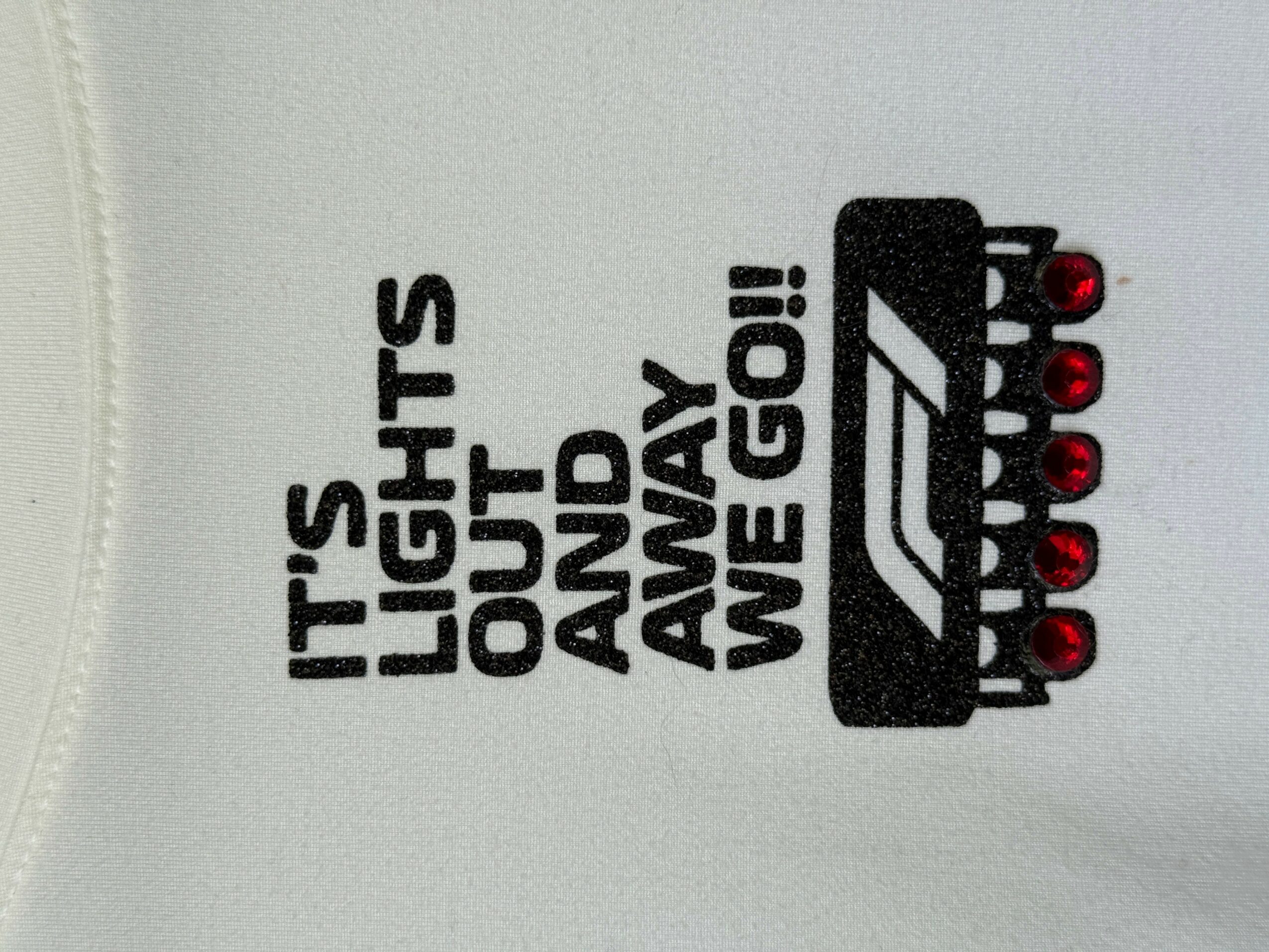 Sticker with text and a graphic of a tank, reading 'IT'S LIGHTS OUT AND AWAY WE GO!'