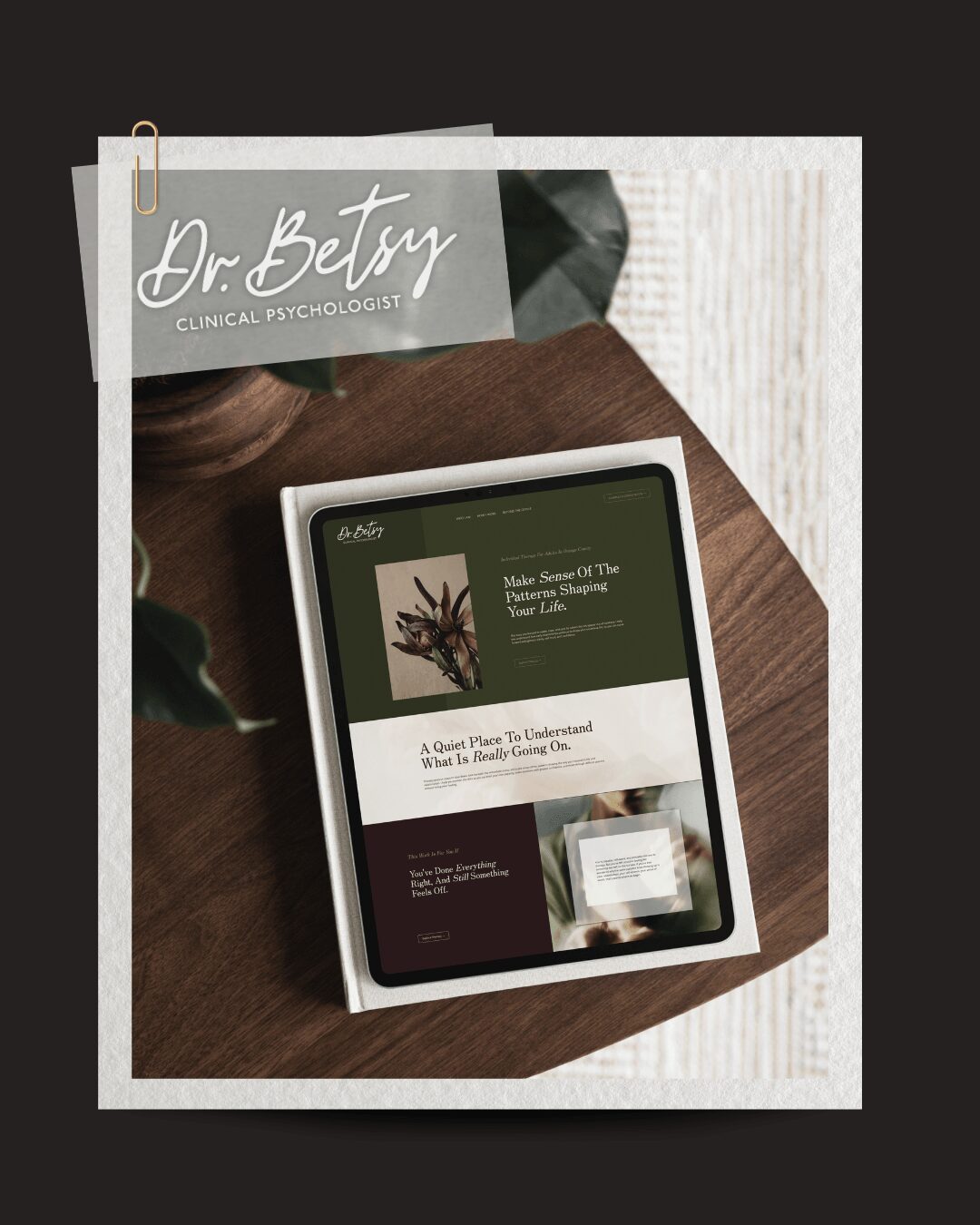 Tablet on wooden surface displaying a website, with a paper labeled 'Dr. Betsy' and a plant nearby.