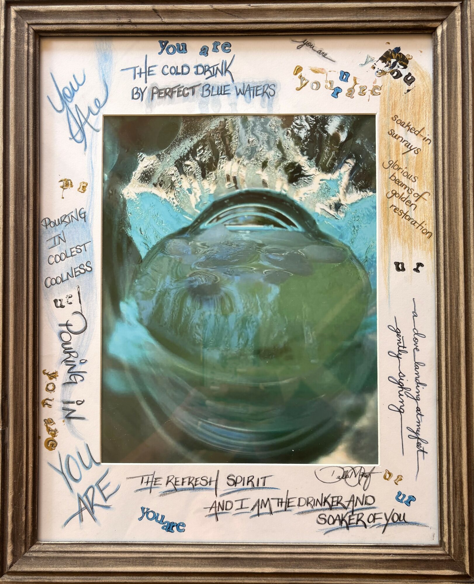 Framed artwork with handwritten notes and a central painting of a water droplet on a reflective surface, surrounded by colorful messages.