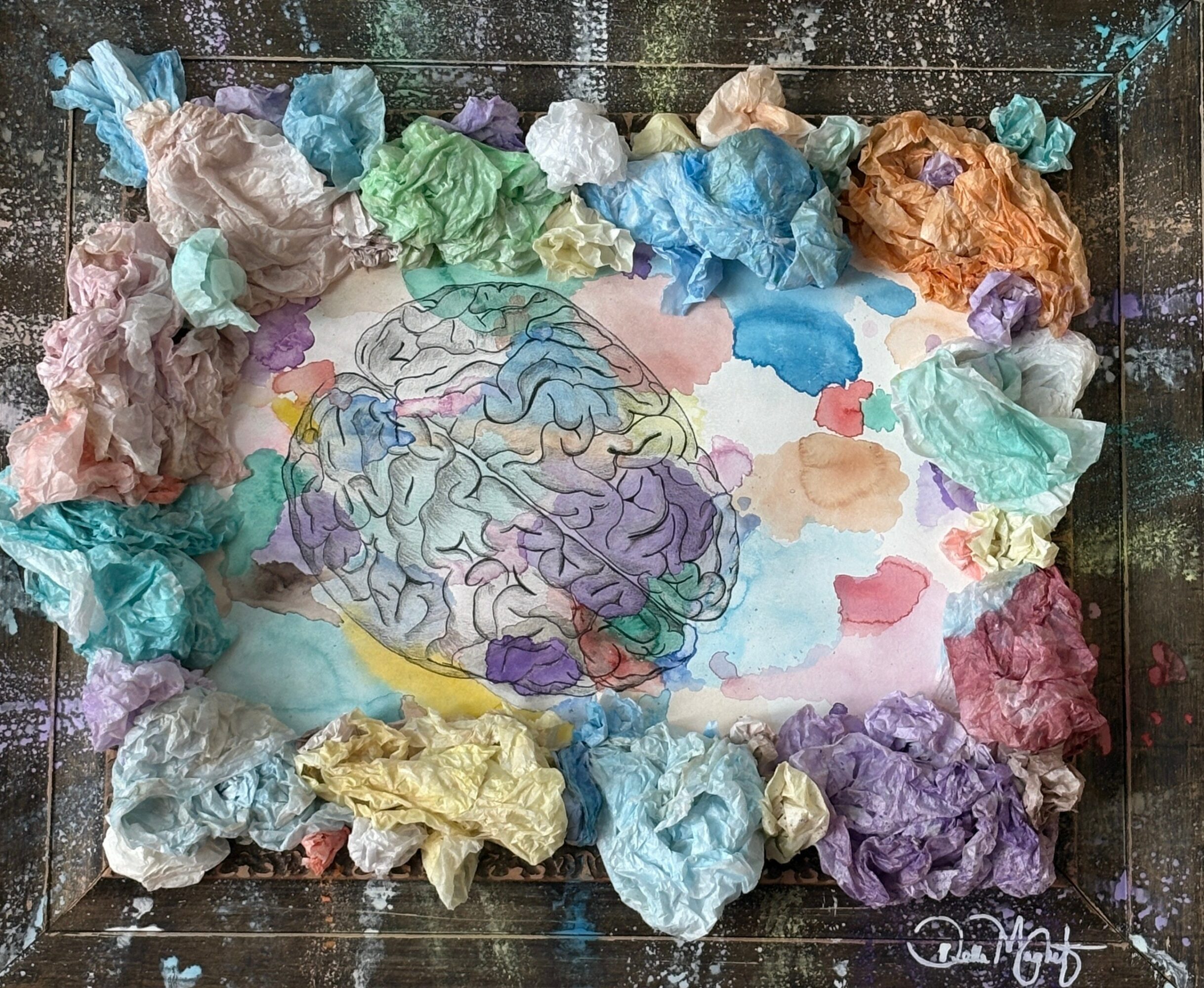 Colorful crumpled paper surrounds a drawing of a face with flowing hair, on a white background.