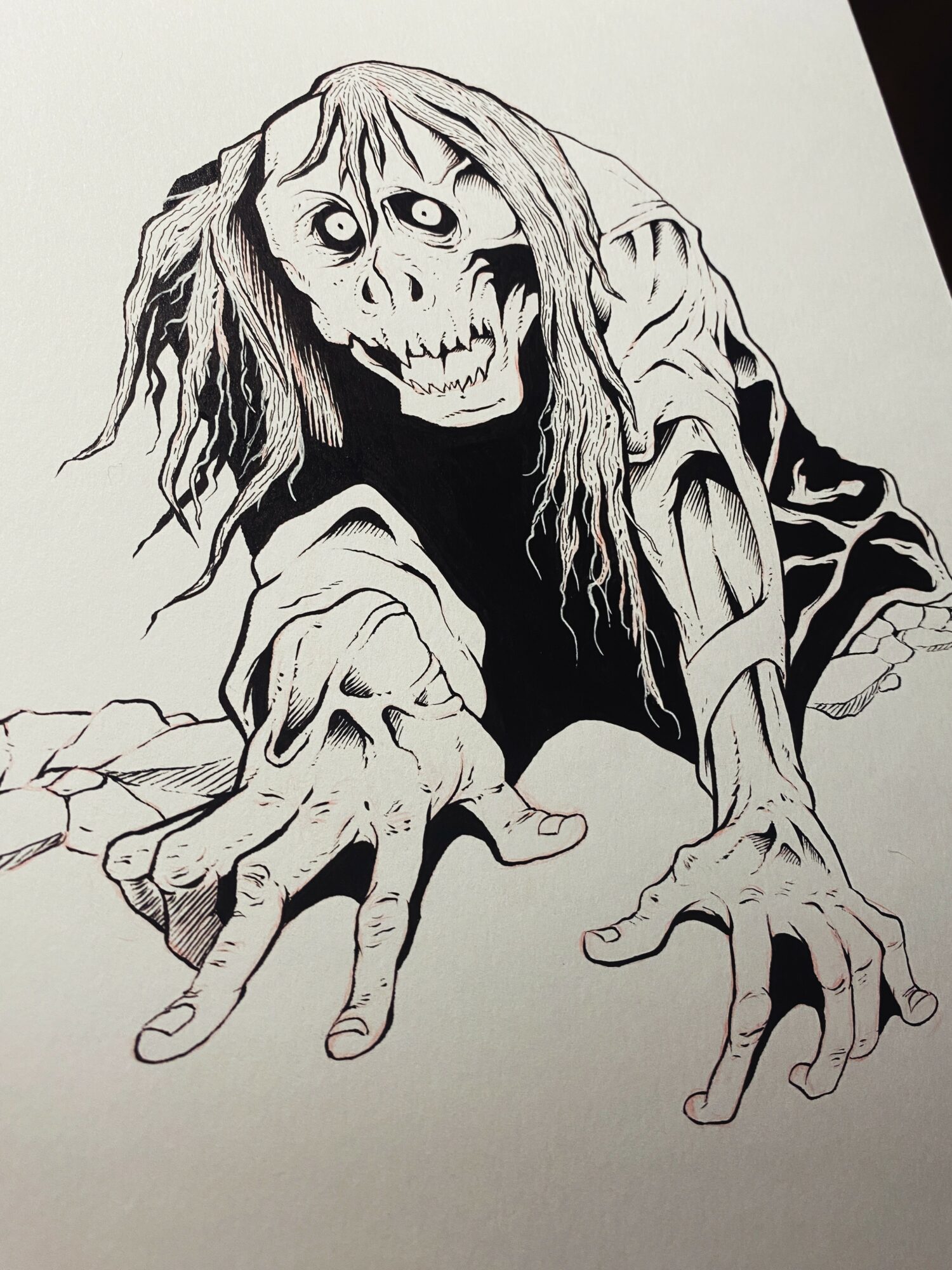 A drawing of a zombie-like figure with long hair, reaching forward with hands on the ground, in black and white.