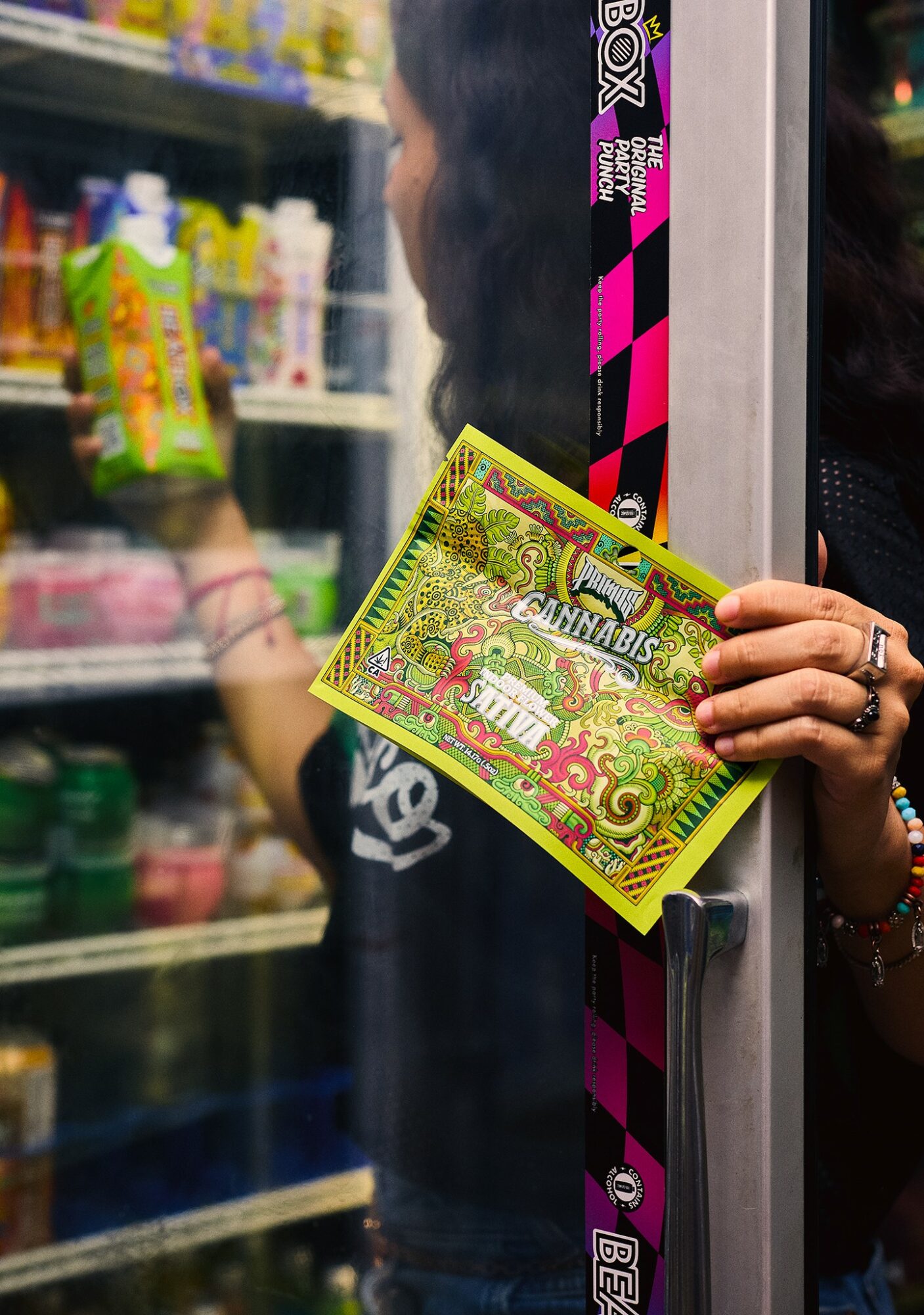 Person holding a colorful card in a store, with shelves of products visible in the background.