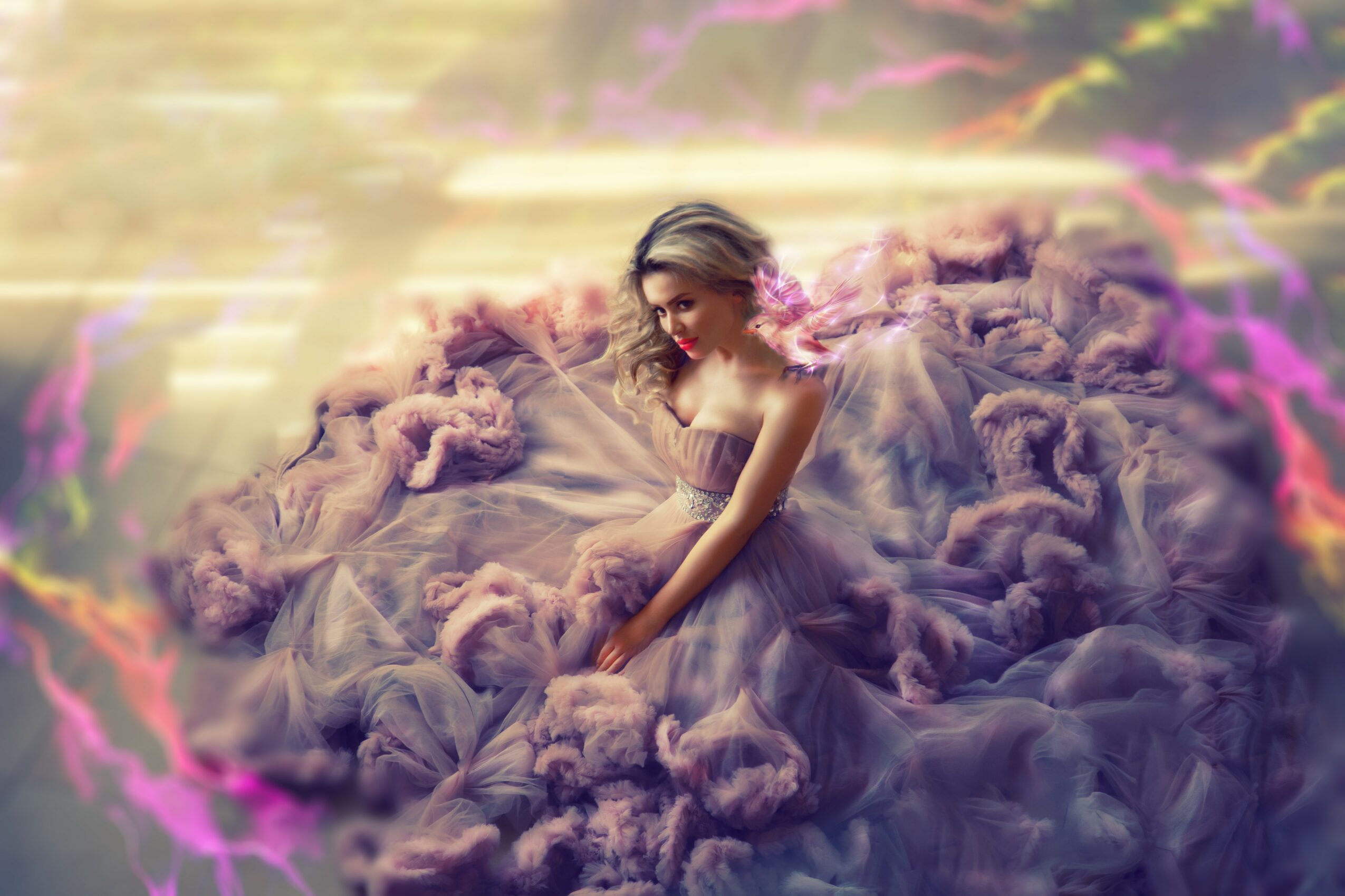 A woman in a flowing dress sits among pink and purple fluffy clouds outdoors, with a blurred background and colorful light effects.