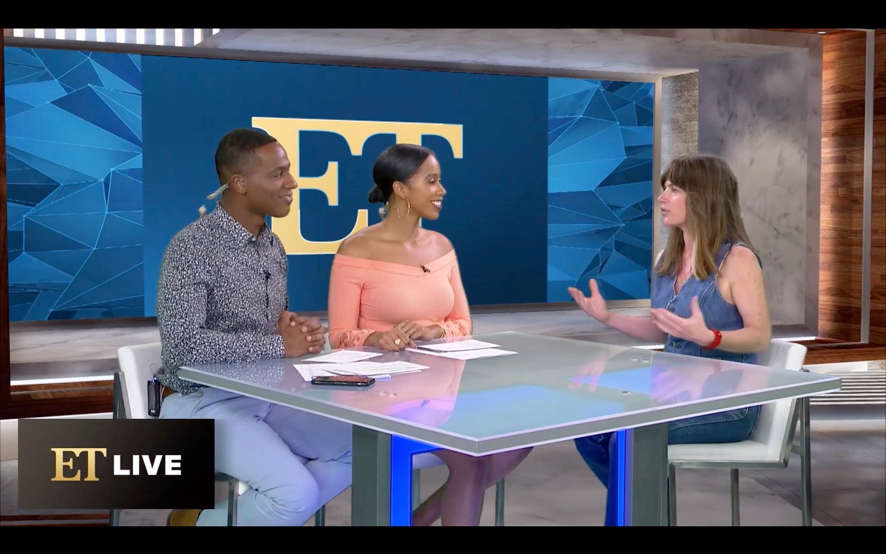 Three women sit at a glass table in a TV studio, engaged in conversation, with a blue geometric background and 'ET' logo.