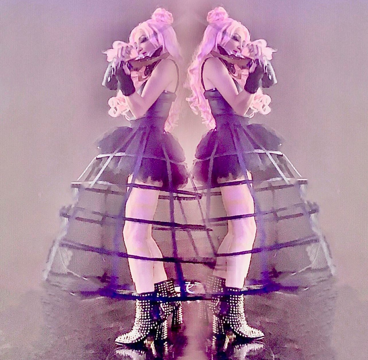 Two mirrored women in purple dresses and high-heeled boots, standing back-to-back, with a layered skirt and ruffled headpiece.