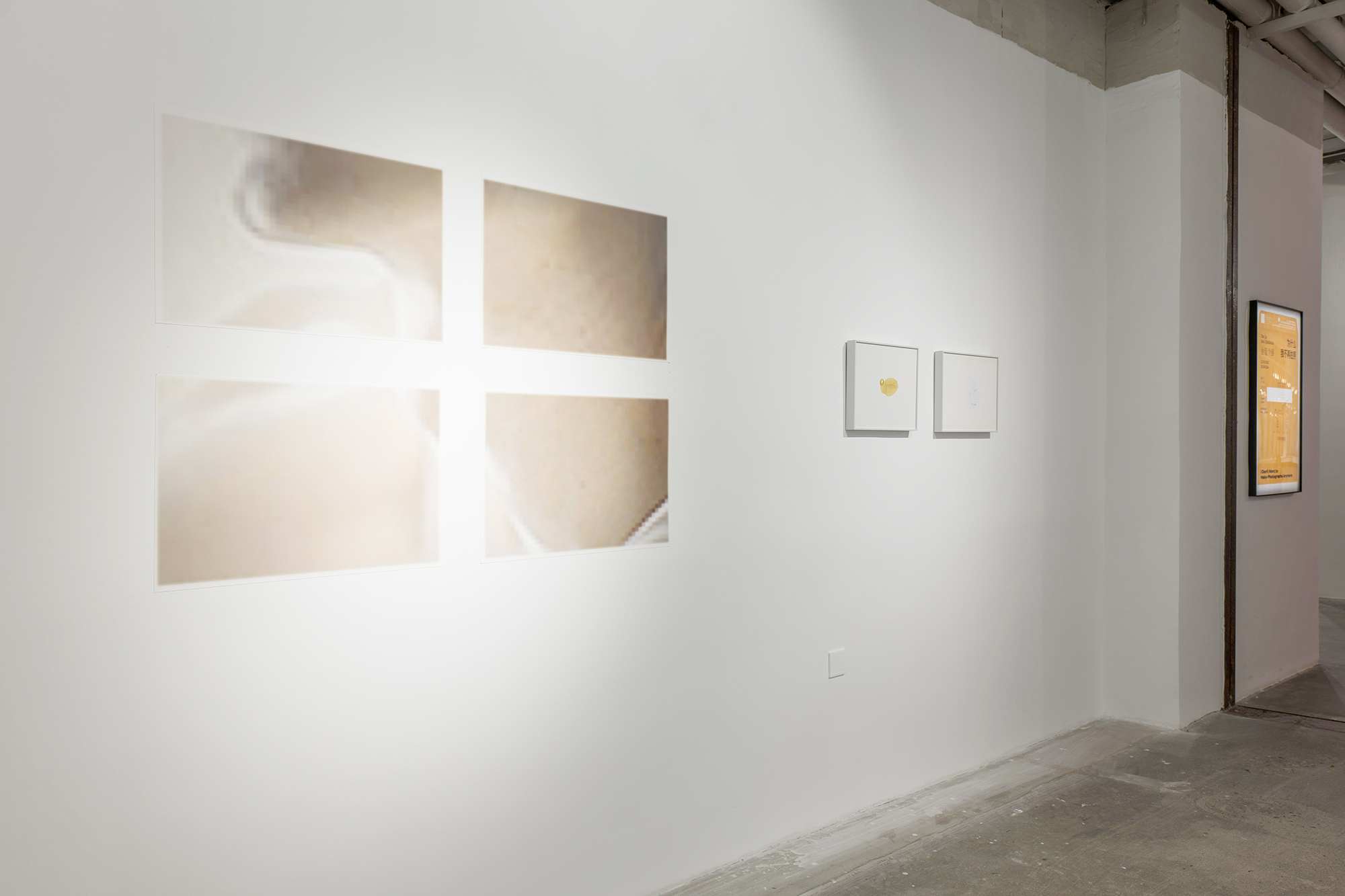 Gallery wall with four abstract art pieces and two small framed artworks, with a bright light source on the left.