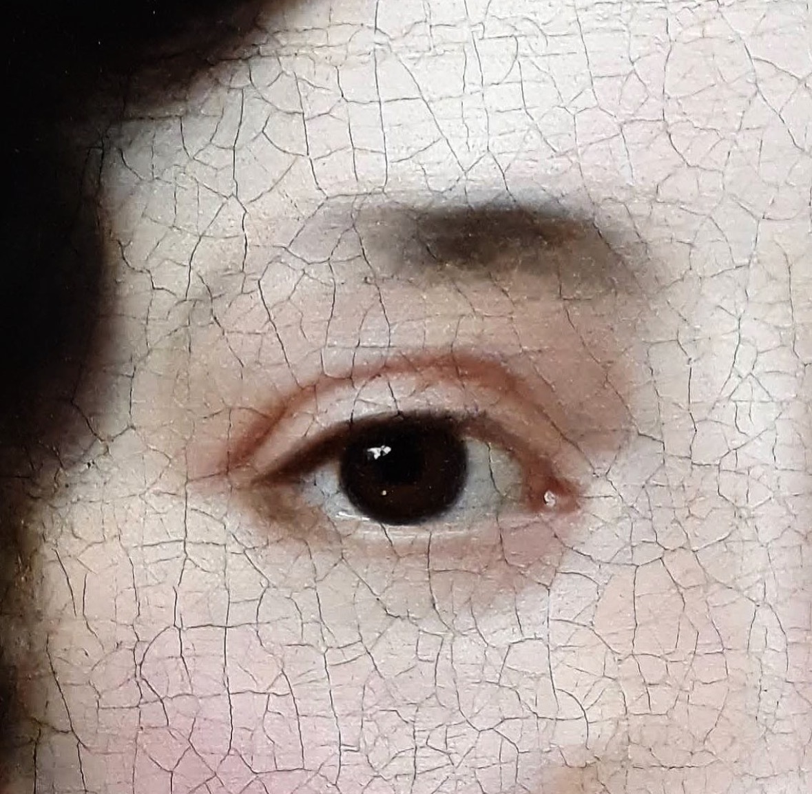 Close-up of a person's eye with cracked, aged skin texture visible around it.