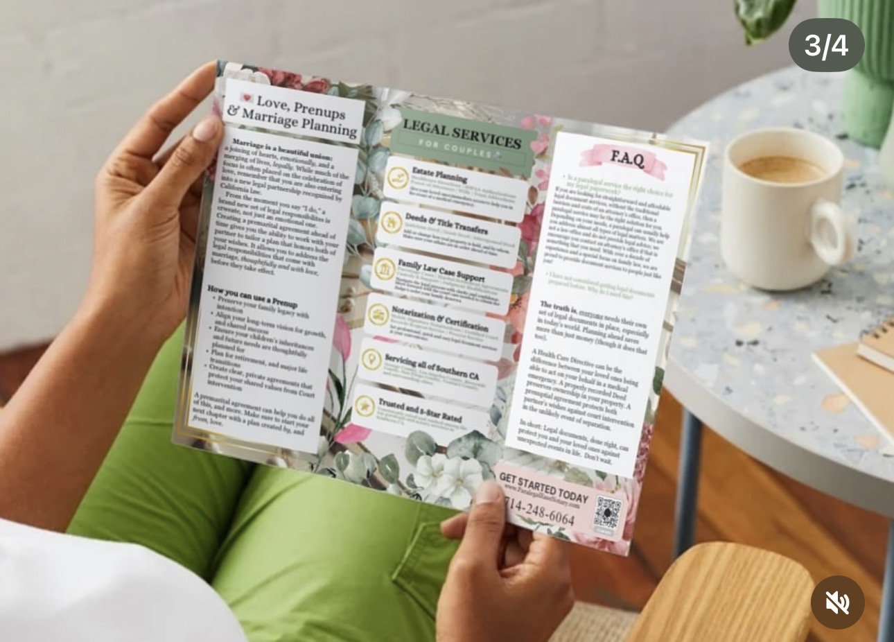 Person holding an open brochure with legal service information, sitting at a table with a coffee cup nearby.
