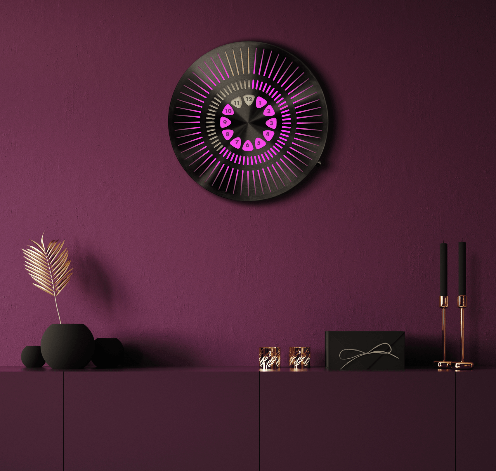 Decorative wall clock with pink and purple design hangs on a purple wall above a purple cabinet with a black vase, candles, and candlesticks.
