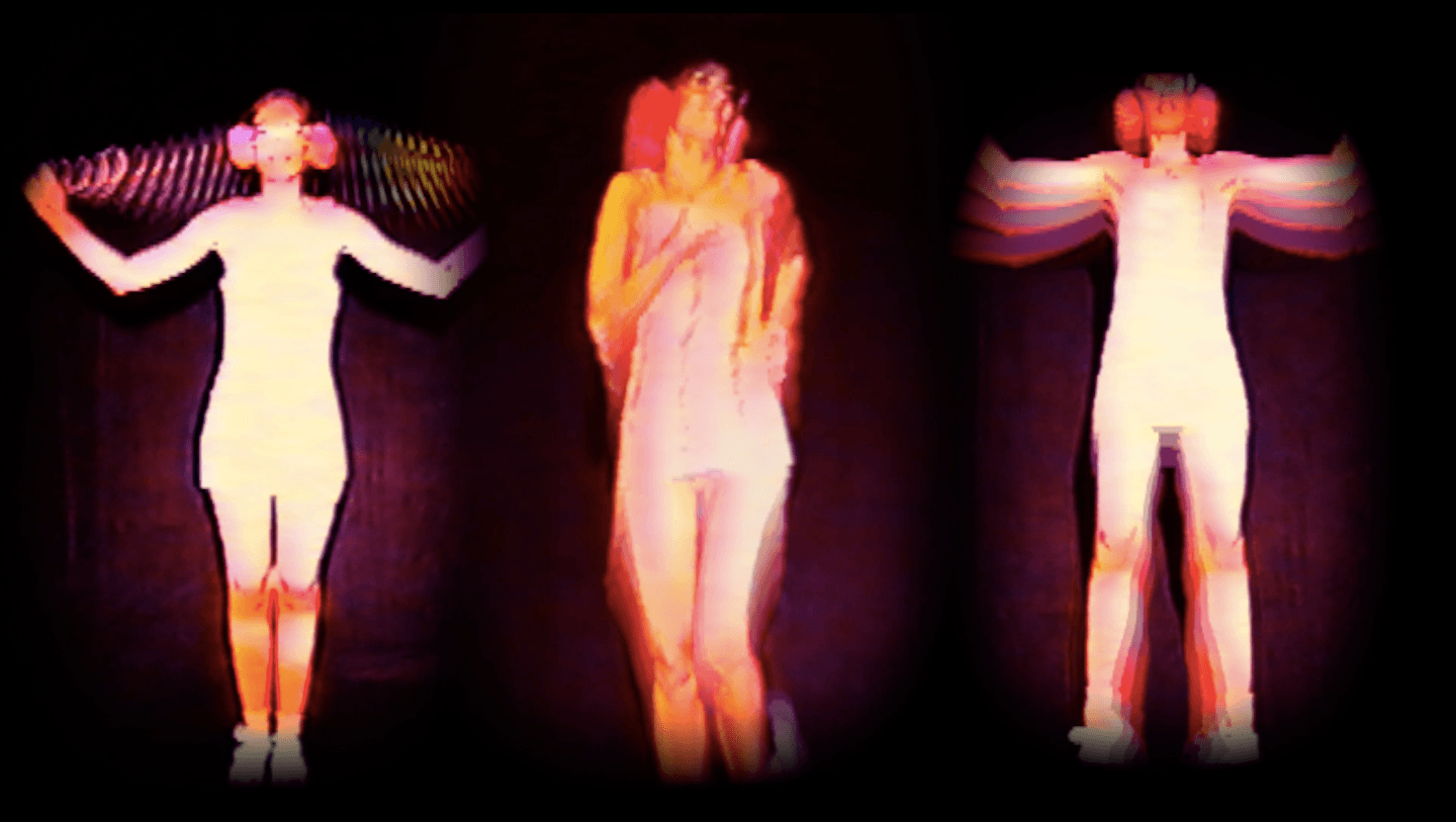 Three performers in white costumes with arms outstretched, standing against a dark background, with colorful light effects.