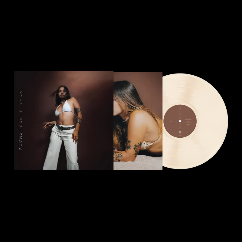 A vinyl record with album cover art featuring a woman in a white outfit and another woman with long hair, lying down.