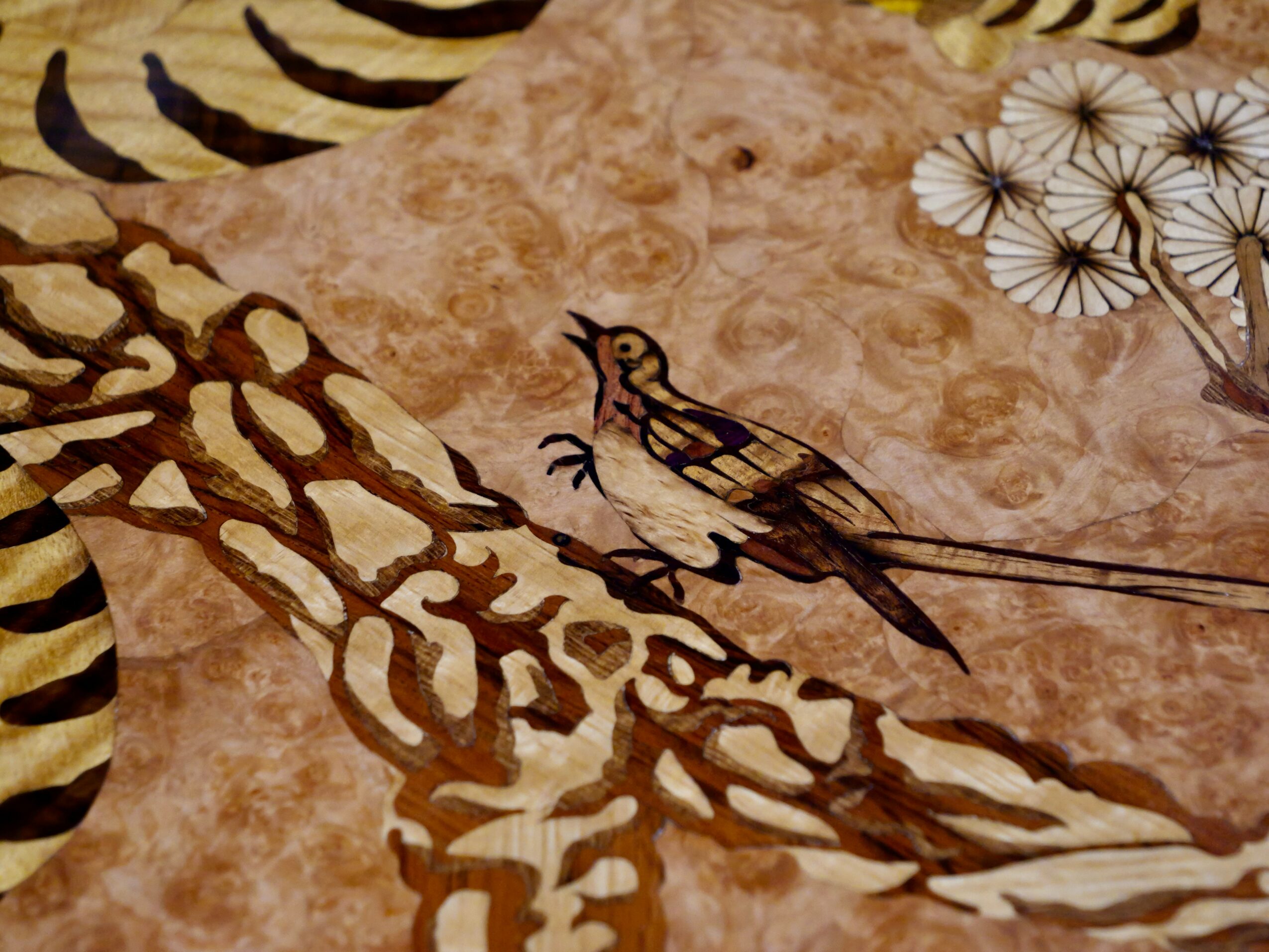 A detailed illustration of a bird perched on a branch with a background of abstract patterns and dandelion-like flowers.