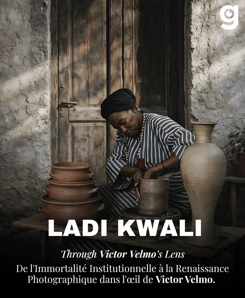 Woman with braided hair in striped shirt arranging pottery in front of a wooden door and stone wall.