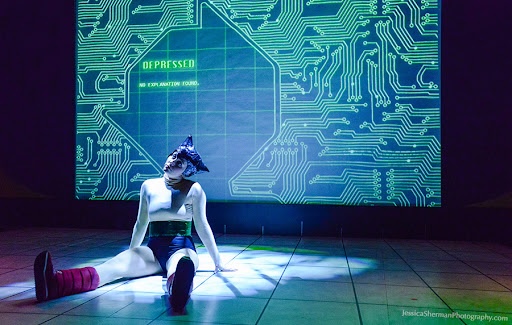Person sitting on the floor with a digital circuit background and the word 'DEPRESSED' displayed.