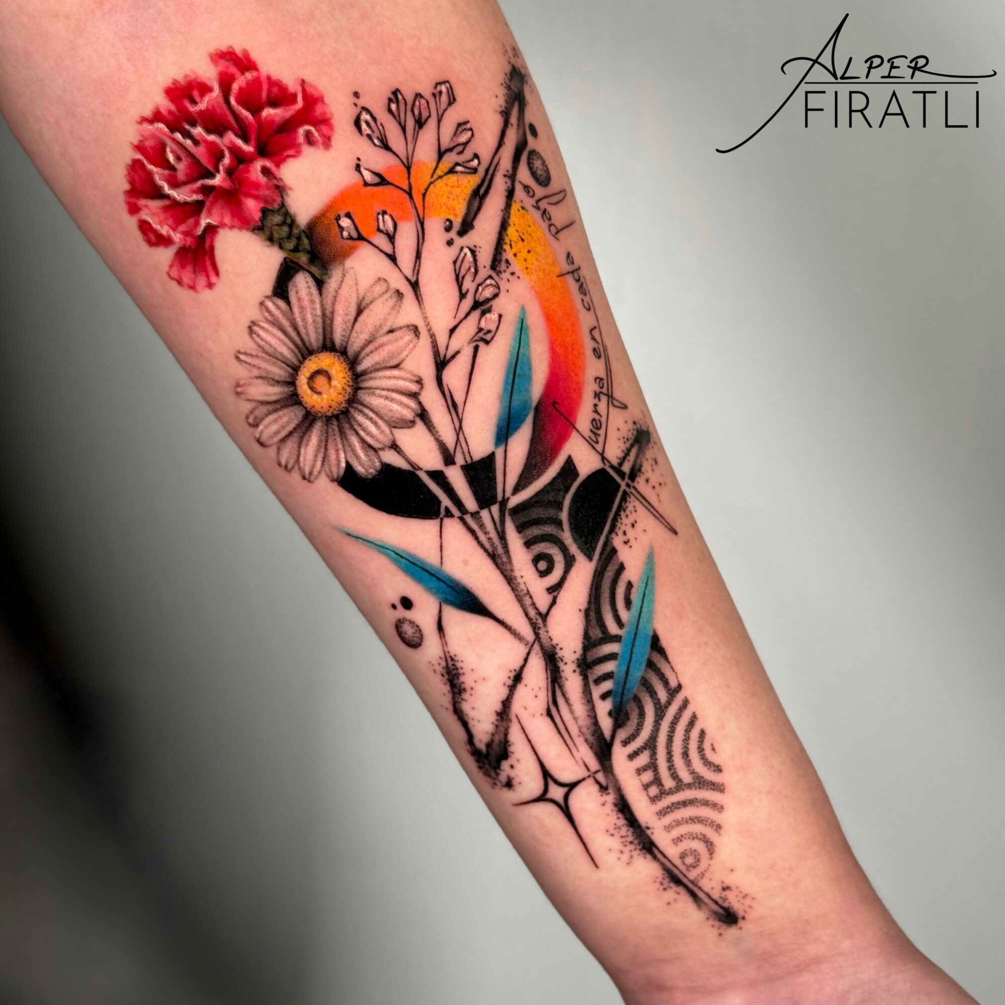 Colorful floral tattoo with flowers, a bird, and abstract elements on a person's arm.