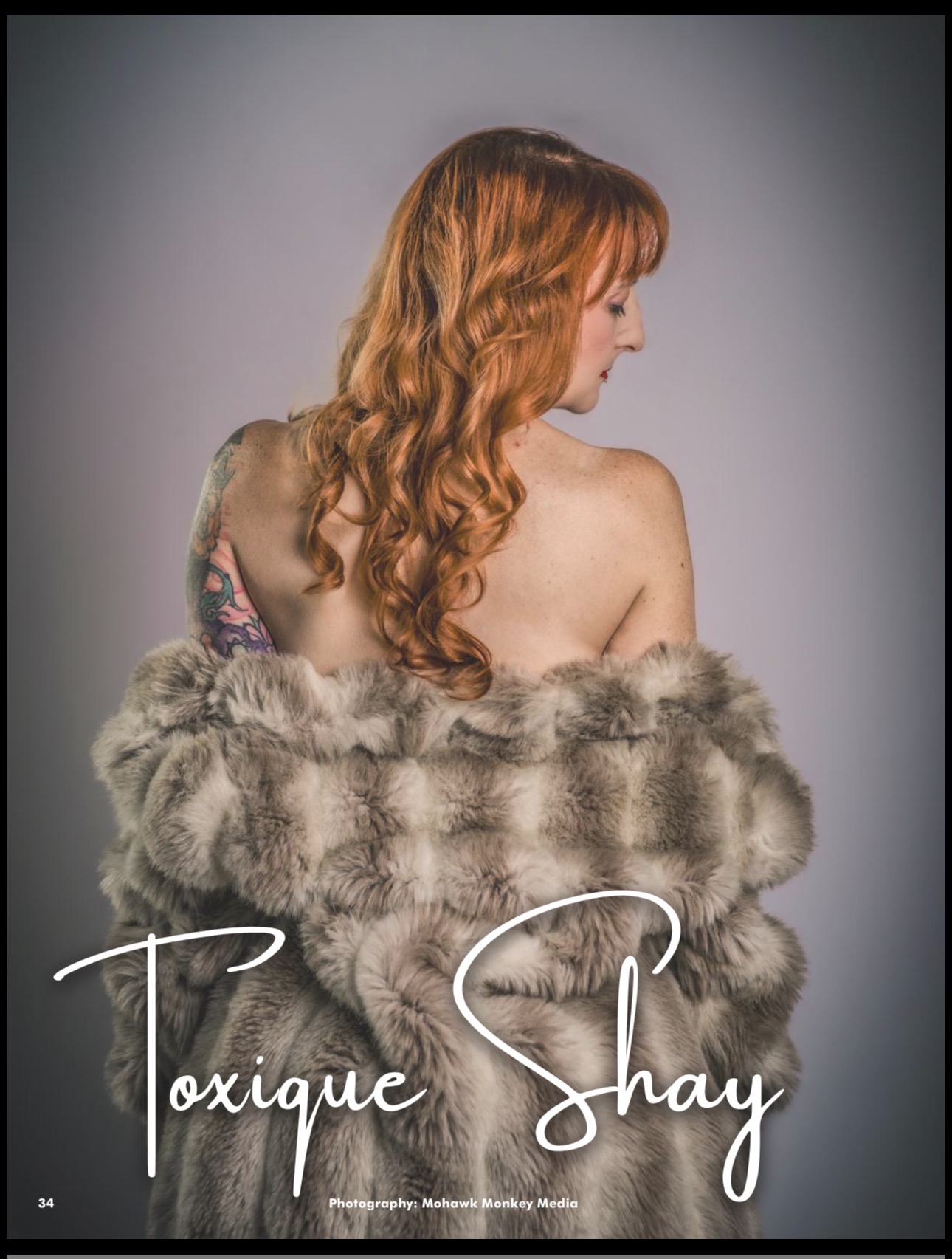 Woman with long, wavy red hair wearing a fur coat, facing sideways, against a plain background.