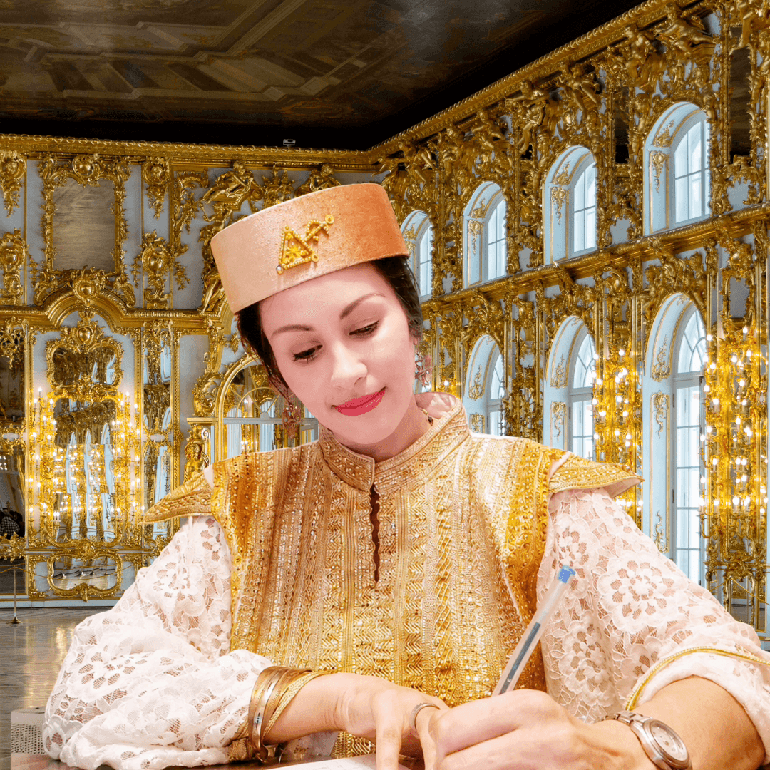 Woman in traditional attire writing, ornate gold and white interior with arched windows behind her.