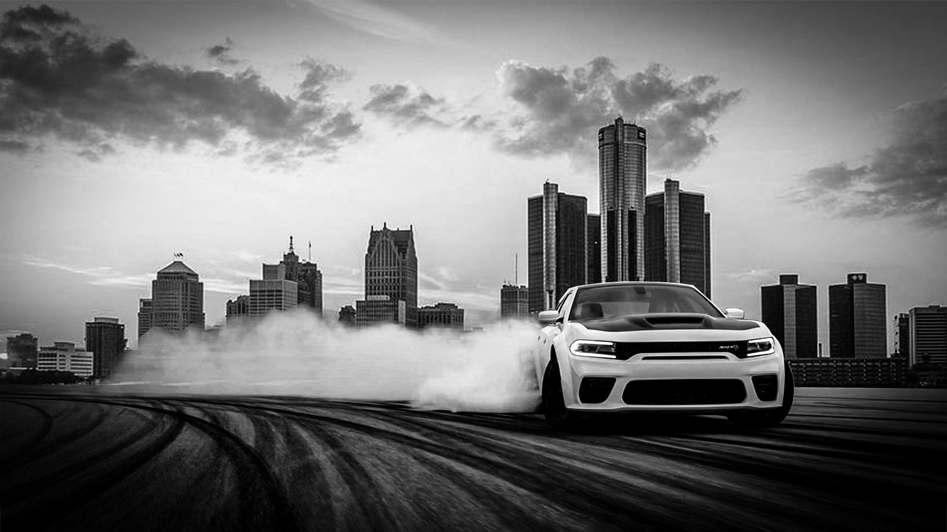 Car drifting on a city rooftop with skyscrapers in the background, black and white image, smoke trails behind the car.