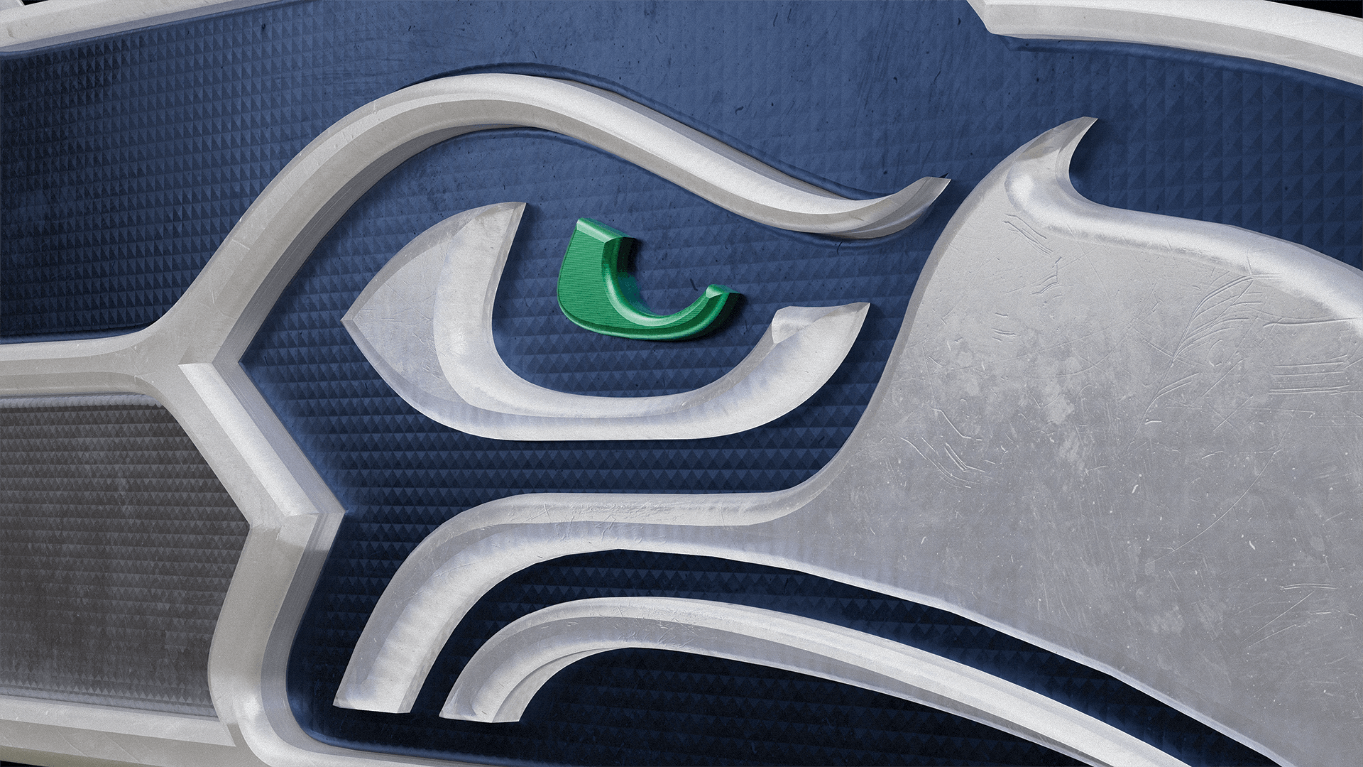 Close-up of a stylized bird logo with a green eye on a textured background.