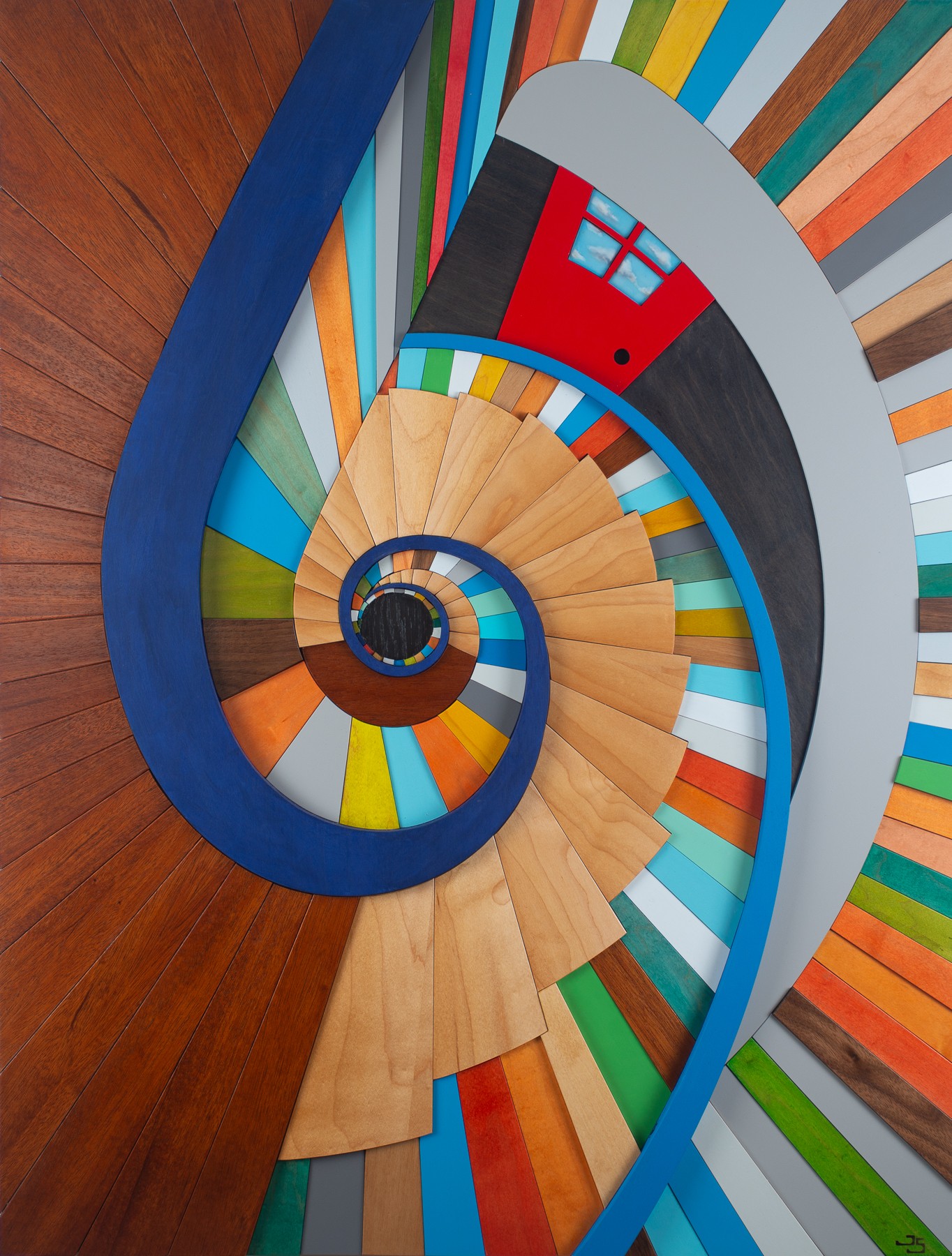 Colorful spiral staircase with a small red house at the top, viewed from above, on a wooden floor.