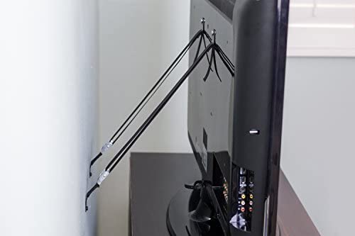 Television on a table with an antenna attached, viewed from the side, in a room with a window.
