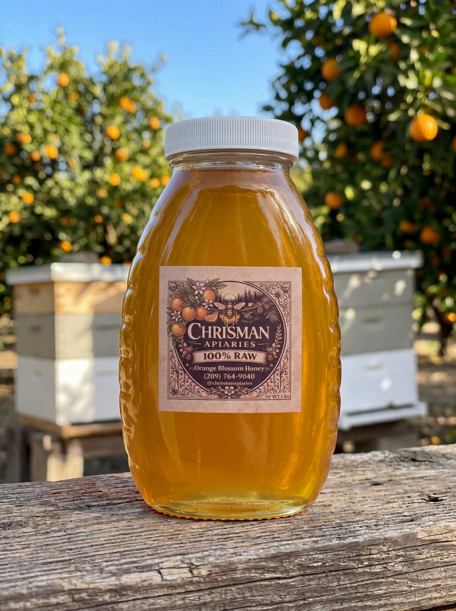 Jar of honey with a label, outdoors with orange trees in the background.