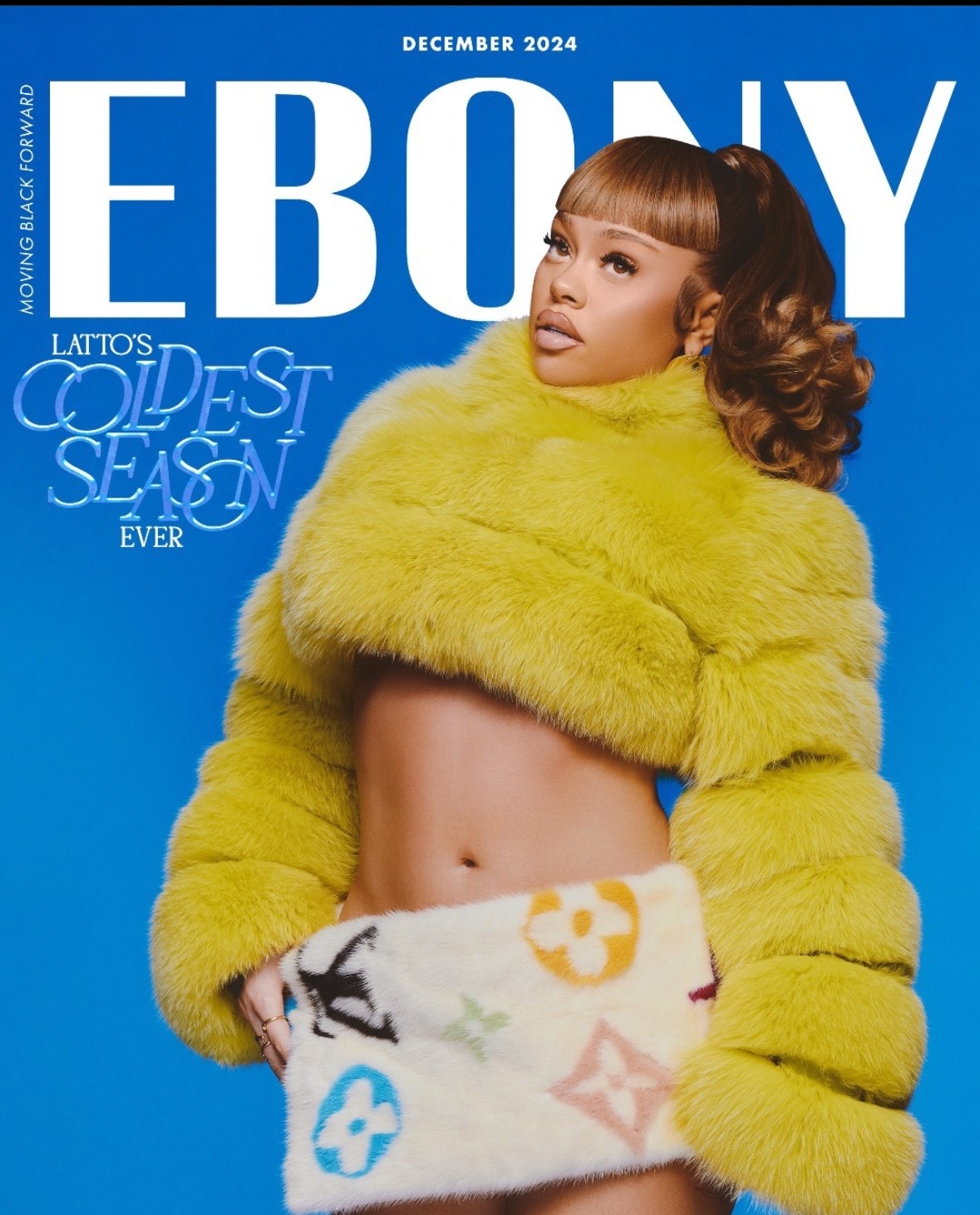 Woman with curly hair wearing a yellow fur coat, exposing her midriff, against a blue background.