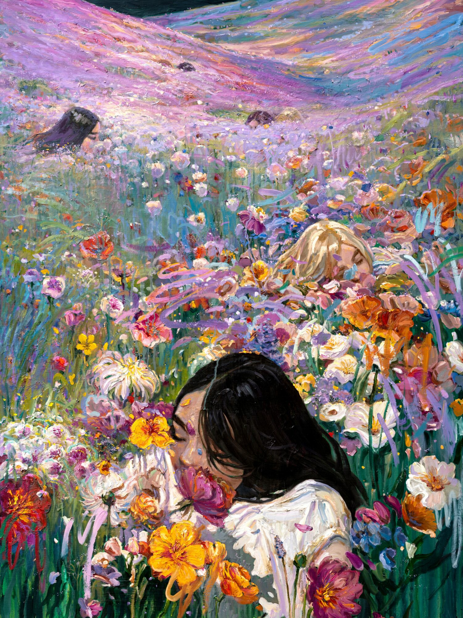 A woman with dark hair among colorful flowers in a vibrant garden landscape.