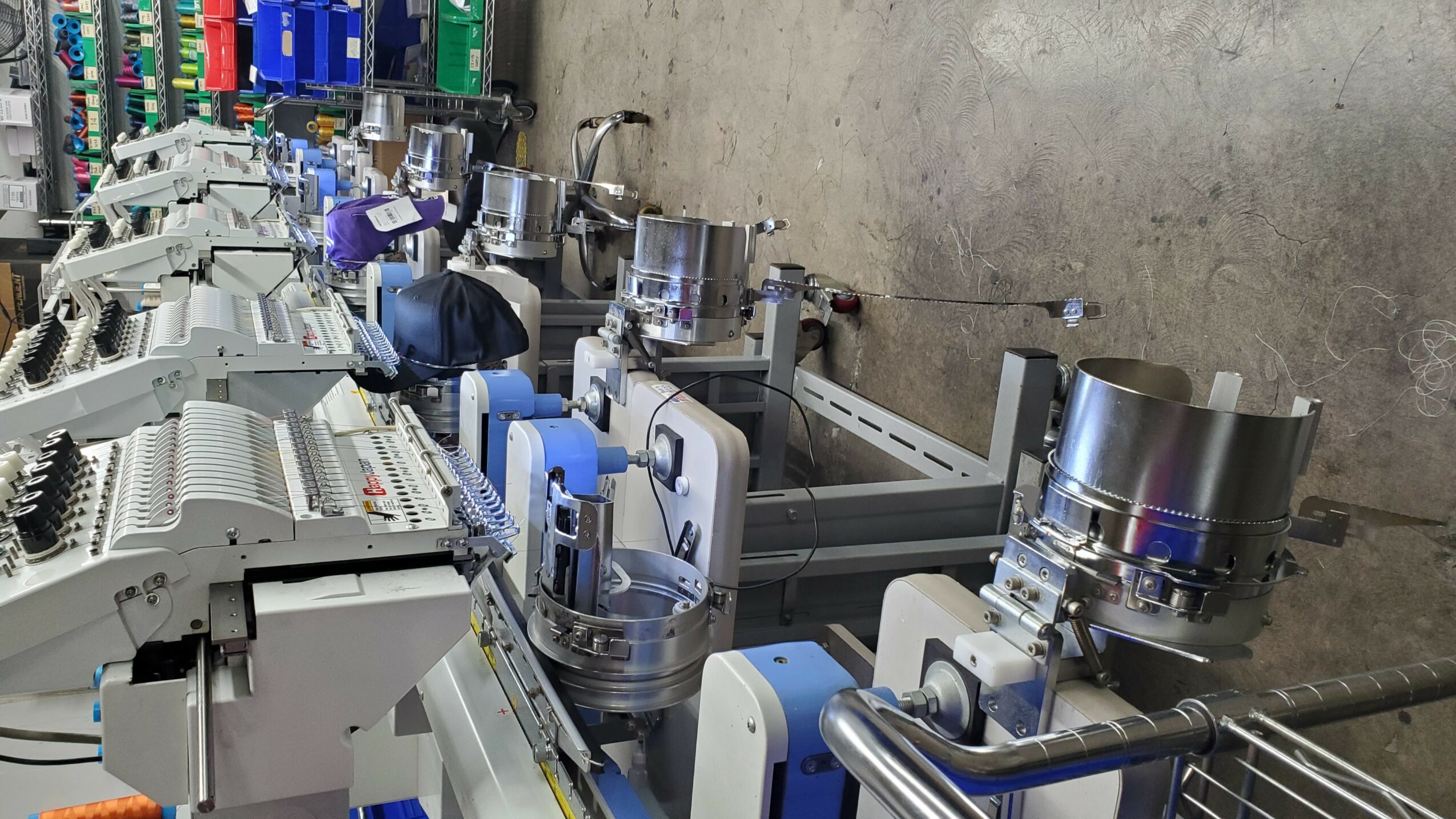 Industrial manufacturing line with machinery and workers in a factory setting.