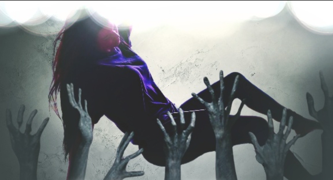 Person with long hair being lifted by multiple hands, silhouette against bright background.