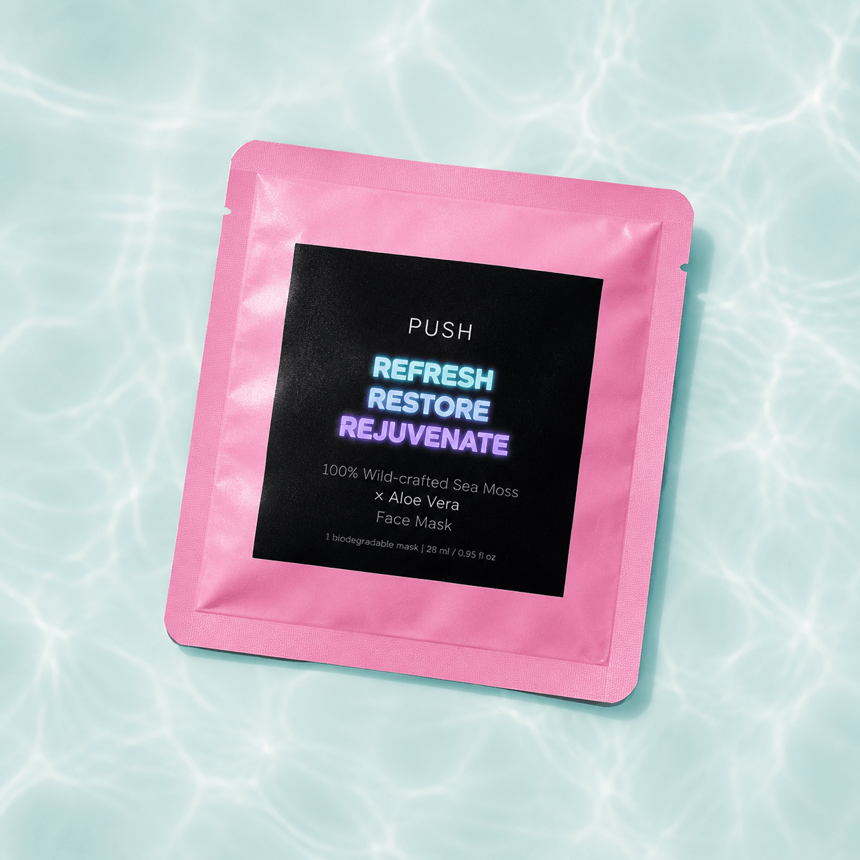 Pink face mask package with black label, text about refresh, restore, rejuvenate, on water background.