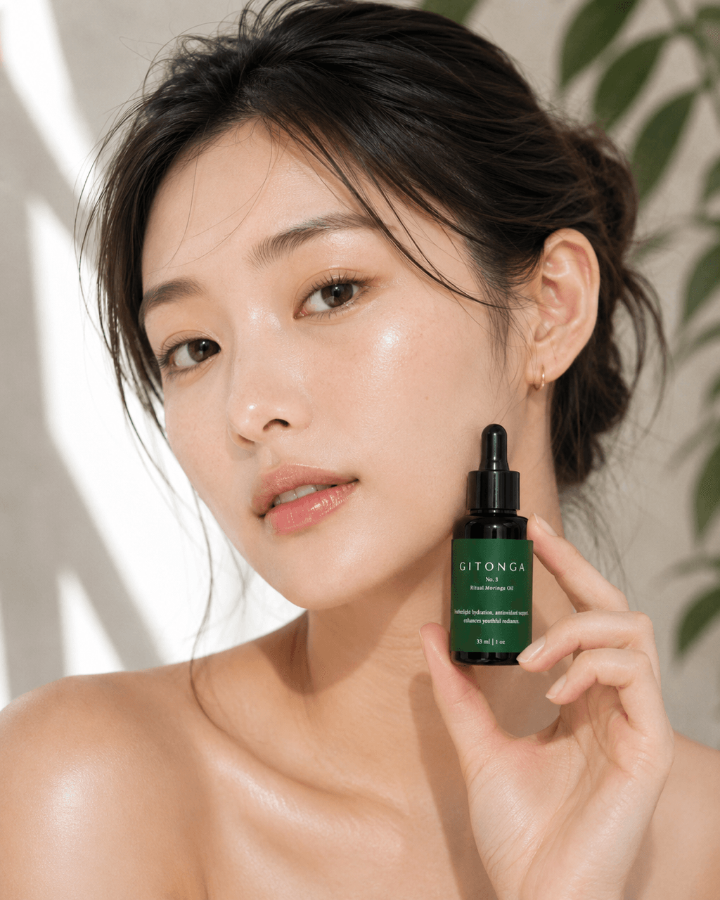 Young woman with dark hair holding a green skincare dropper bottle, looking at camera, natural background.