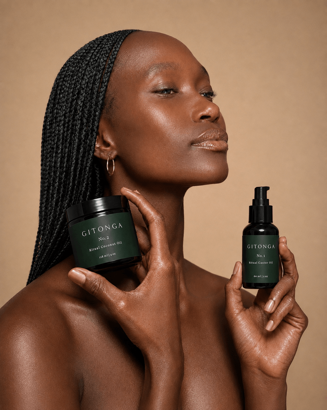 Woman with braided hair holding skincare products against a beige background.