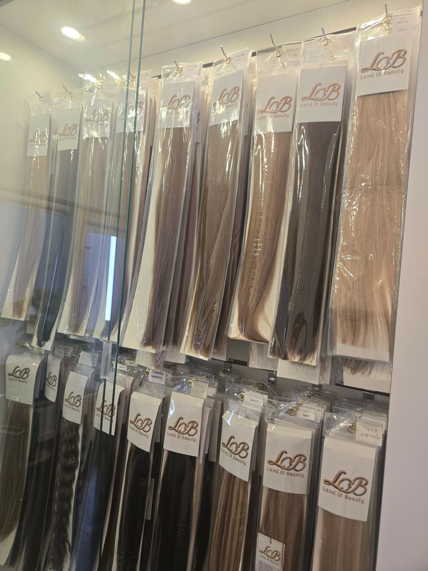 Shelves with neatly arranged fabric or paper rolls, labeled with tags, in a well-lit store or display area.