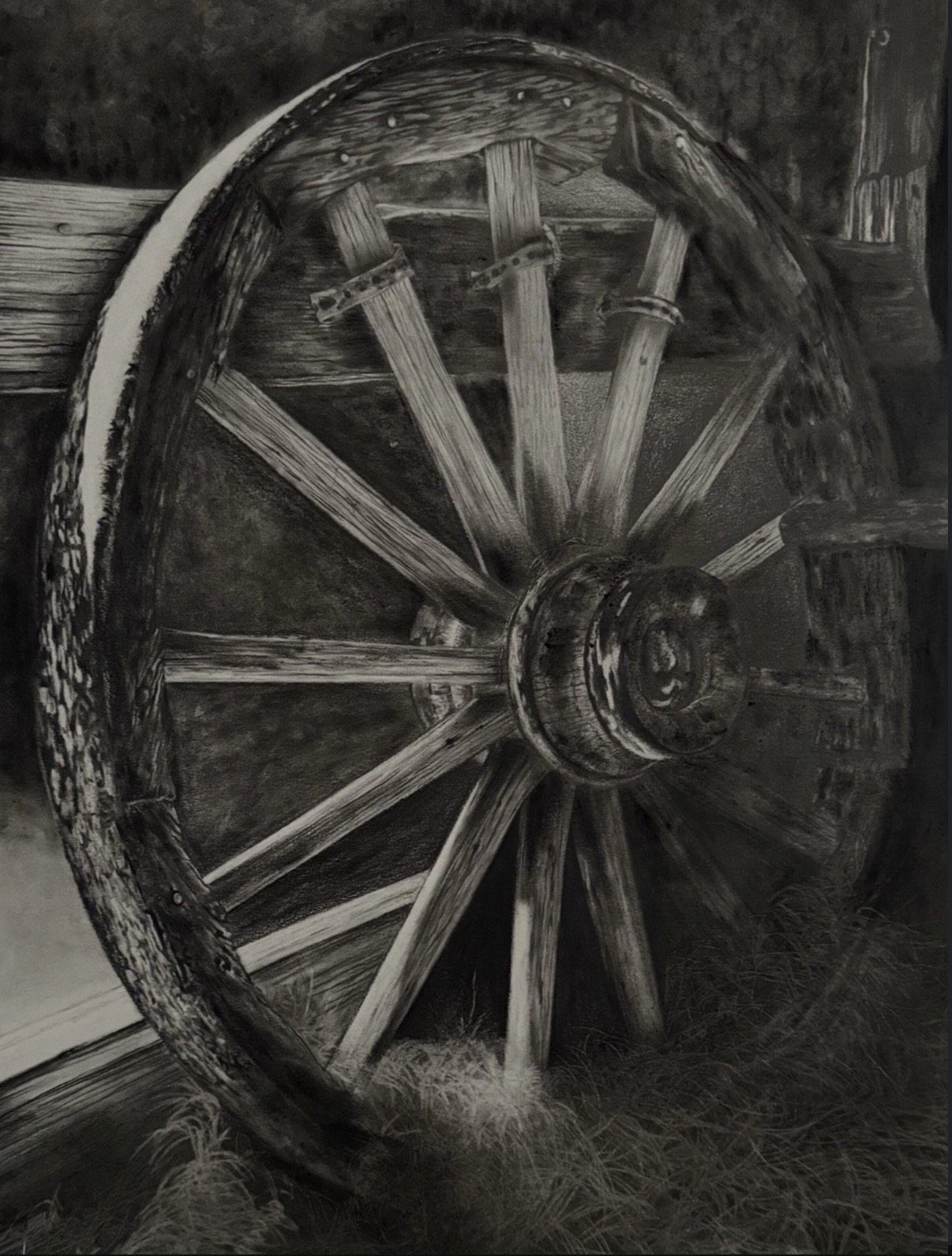 Old wooden wagon wheel leaning against a wall, with visible spokes and hub, in black and white.