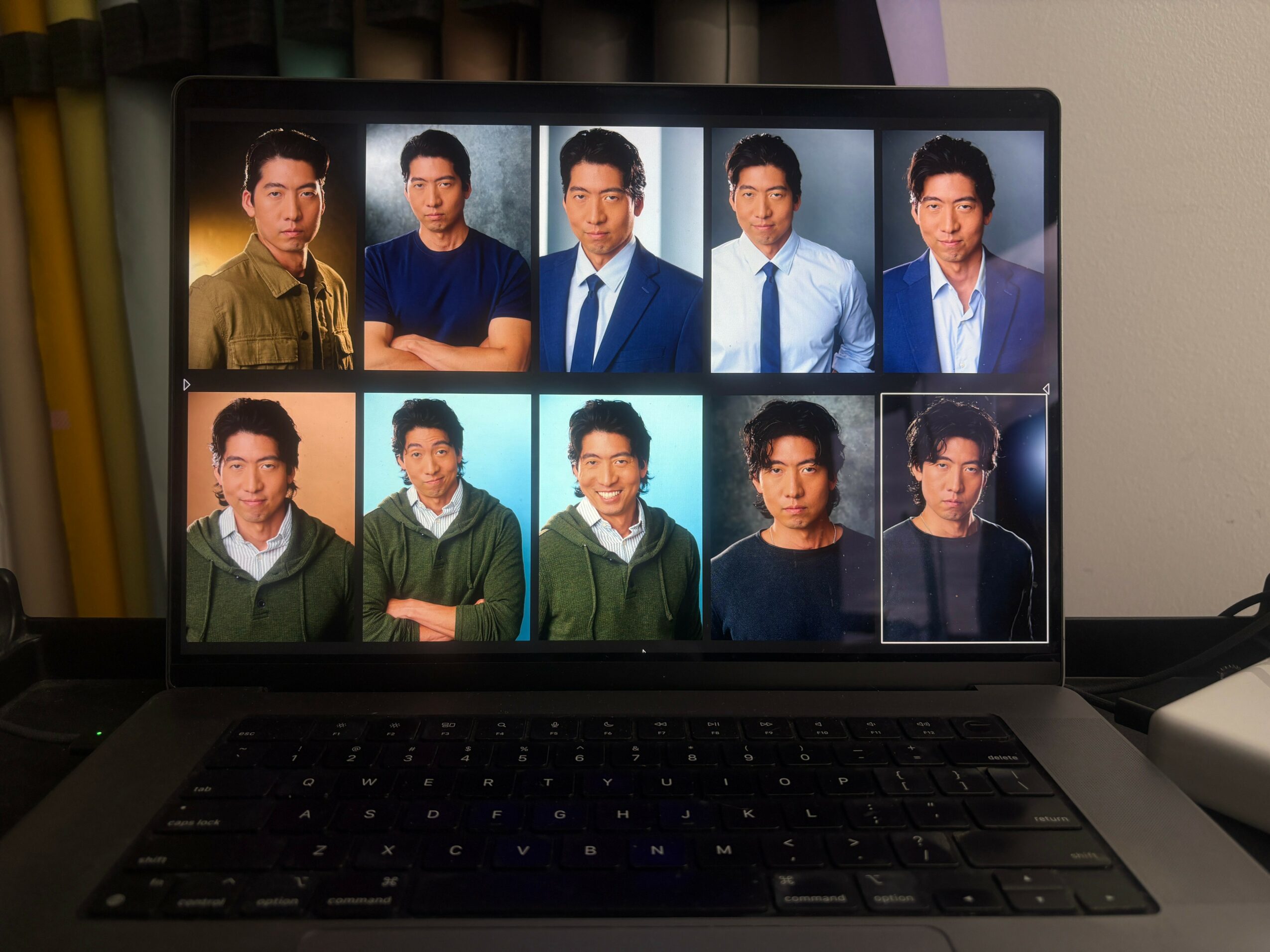Laptop screen displaying ten people in formal and casual attire, arranged in two rows of five, with a neutral background.