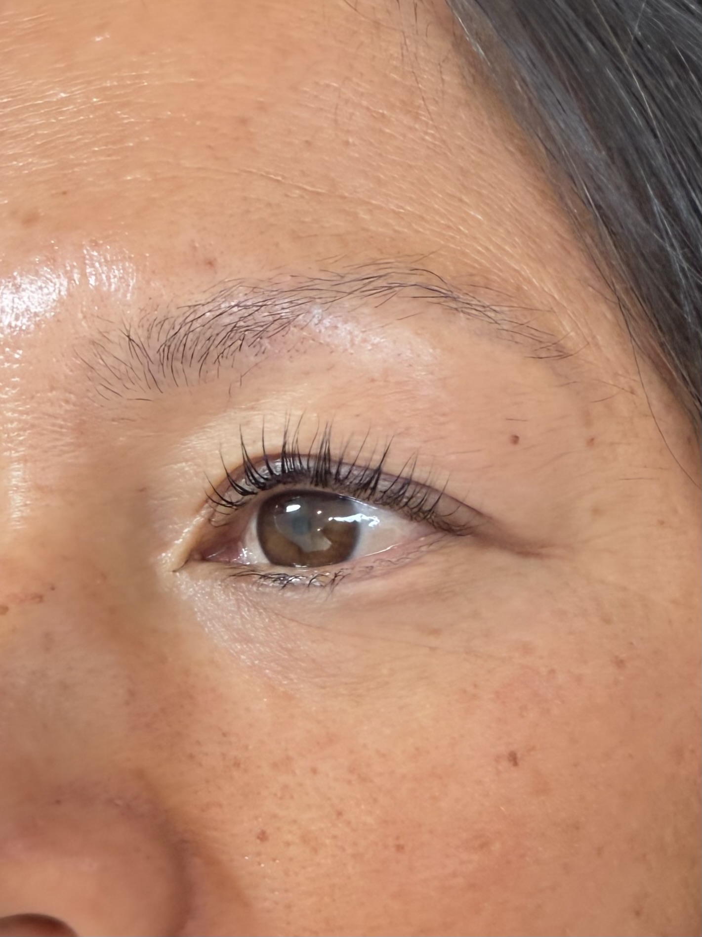Close-up of a person's eye, showing eyelashes, eyebrow, and skin texture.
