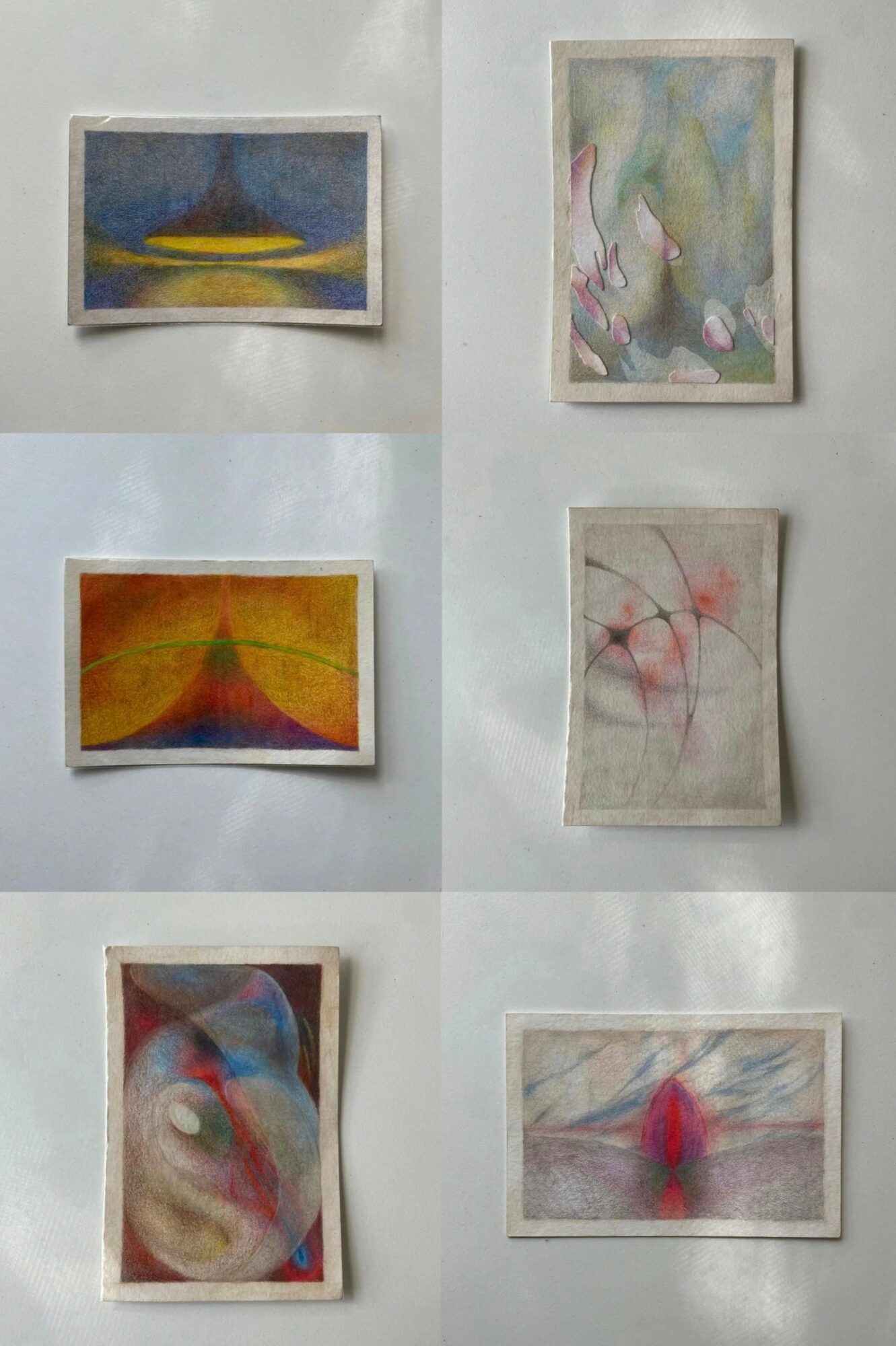Six abstract paintings on a white wall, each with different colors and shapes, arranged in two columns and three rows.