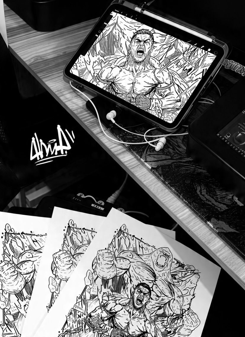 Tablet displaying a comic-style drawing of a muscular man with an angry expression, connected to earphones, on a desk with sketches.