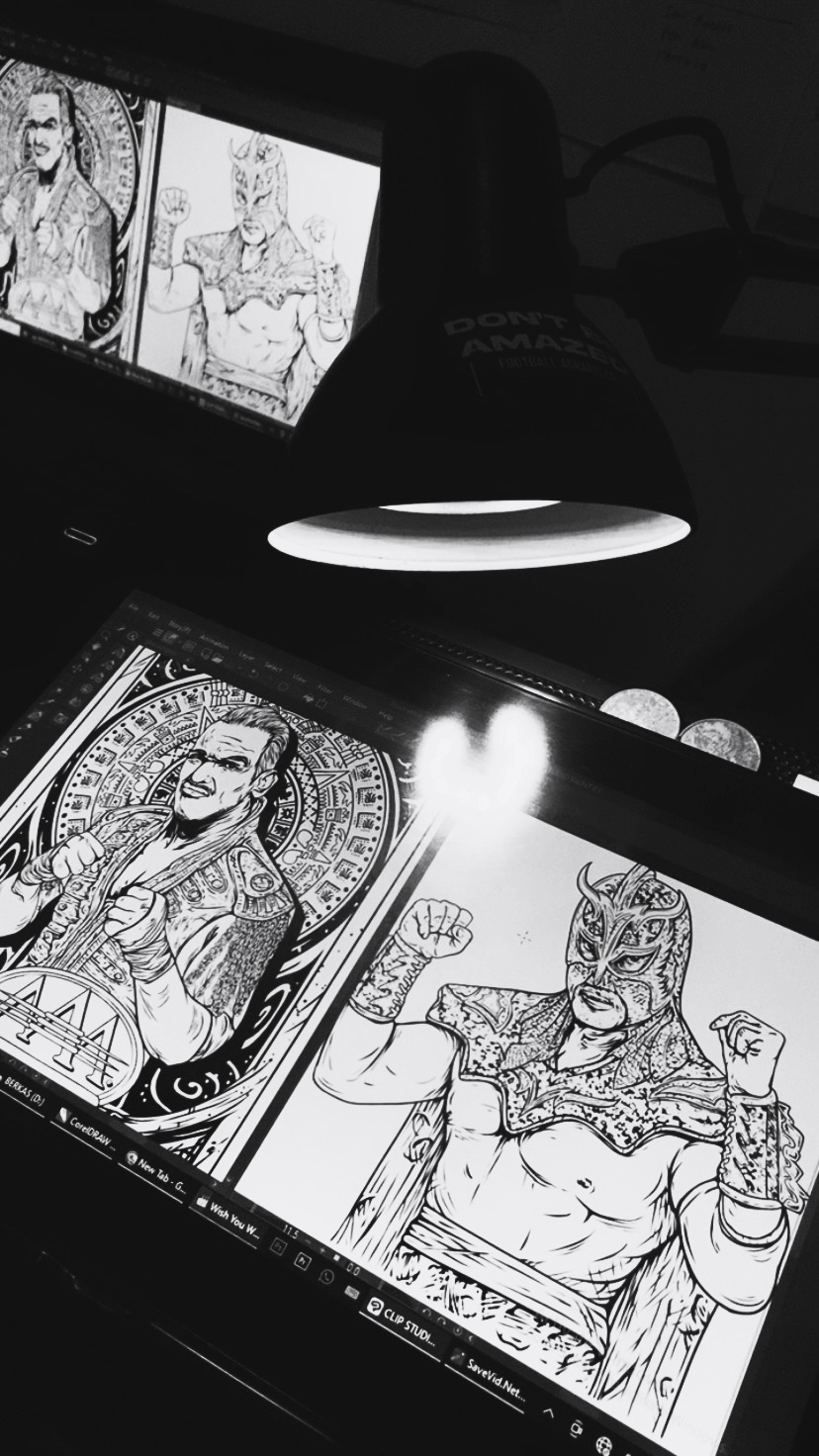 Two black and white illustrations of characters in traditional attire displayed on a screen, with a lamp illuminating the workspace.