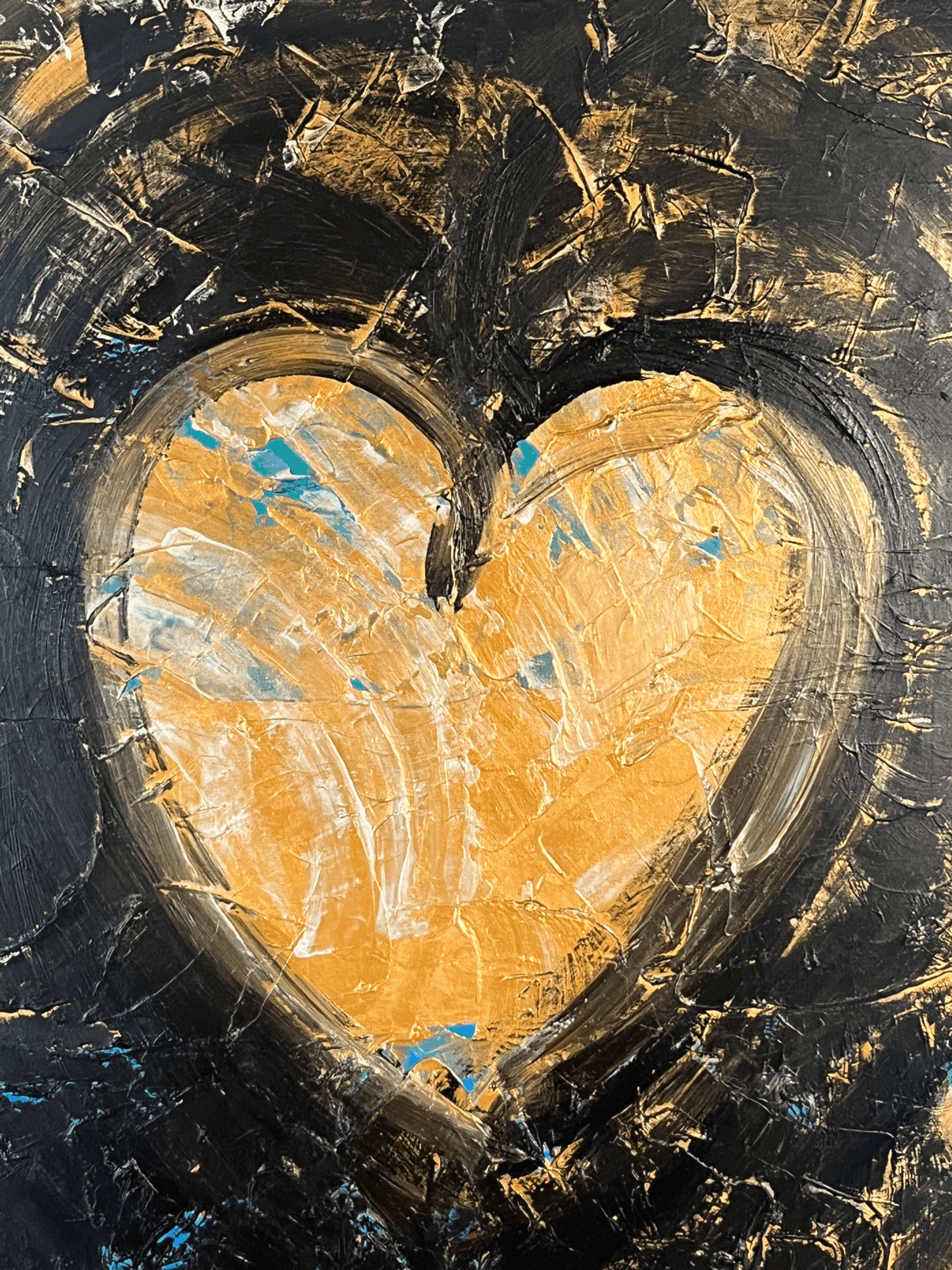 Abstract painting with a large gold heart shape surrounded by black and blue brushstrokes.